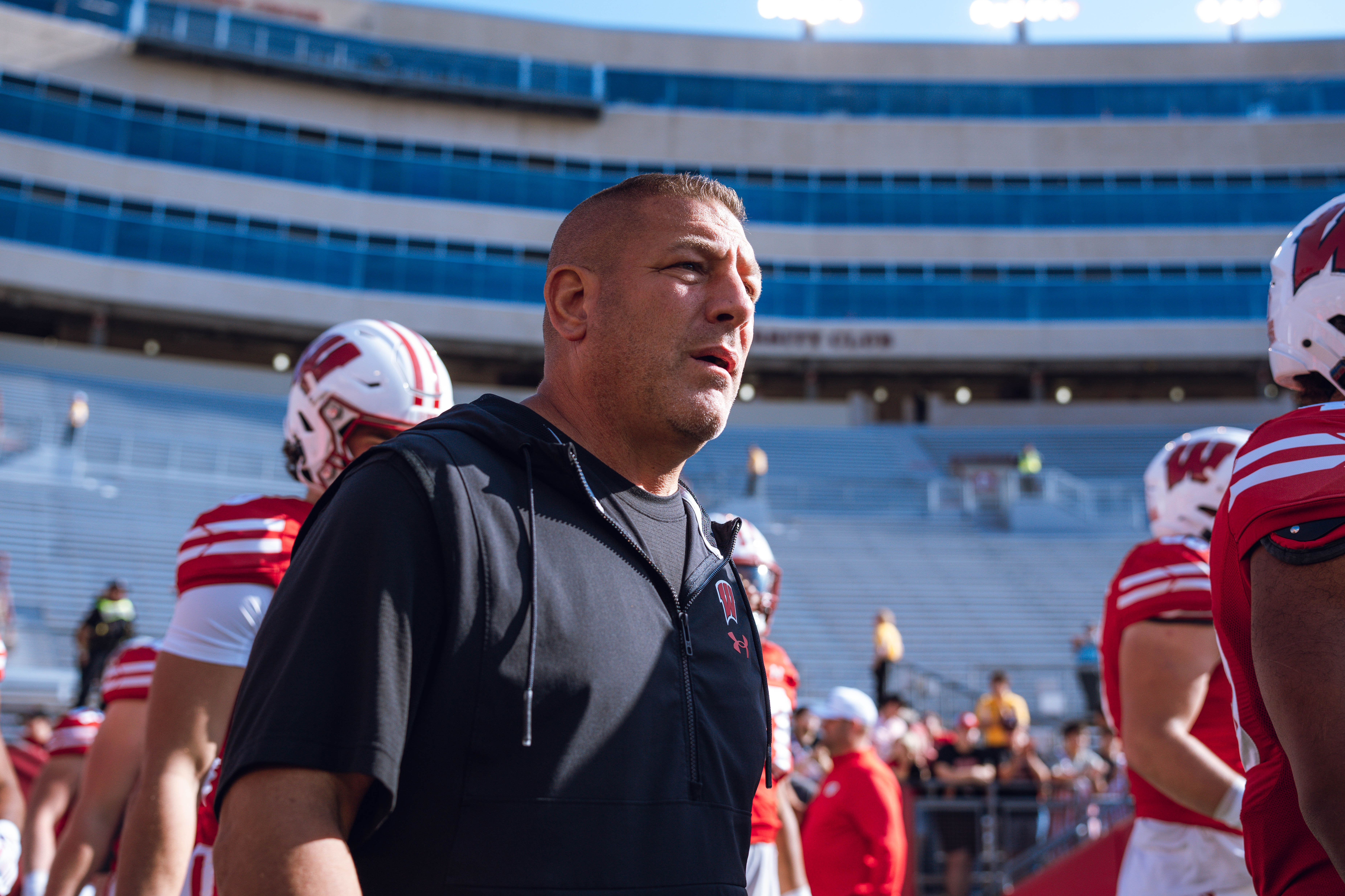 Wisconsin Badgers Offensive Coordinator Phil Longo walks out of the tunnel against the Purdue Boilermakers at Camp Randall Stadium on October 5, 2024 in Madison, Wisconsin. Photography by Ross Harried for Second Crop Sports.