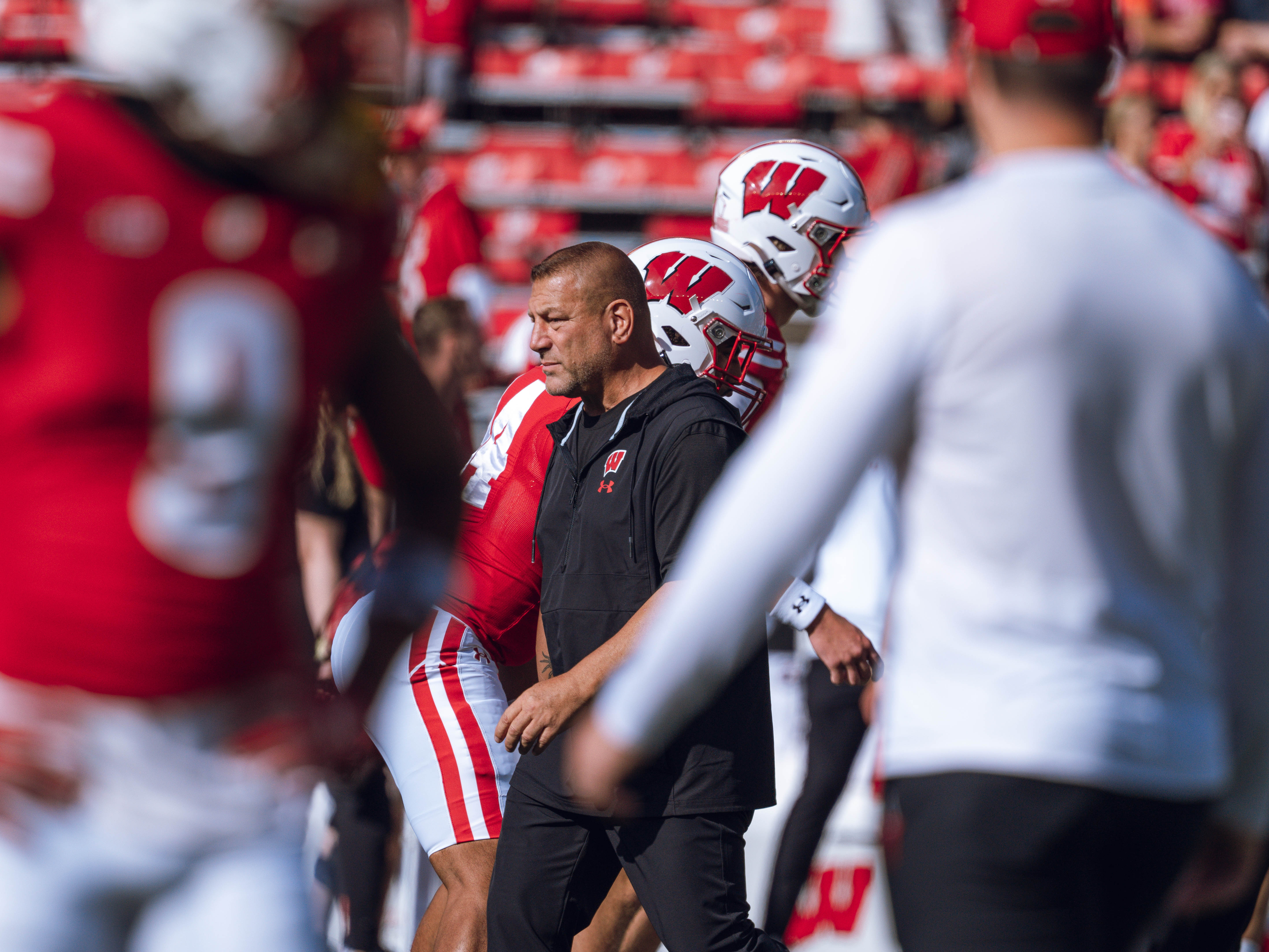 Wisconsin Badgers Offensive Coordinator Phil Longo leads warmups for the Wisconsin Badgers against the Purdue Boilermakers at Camp Randall Stadium on October 5, 2024 in Madison, Wisconsin. Photography by Ross Harried for Second Crop Sports.