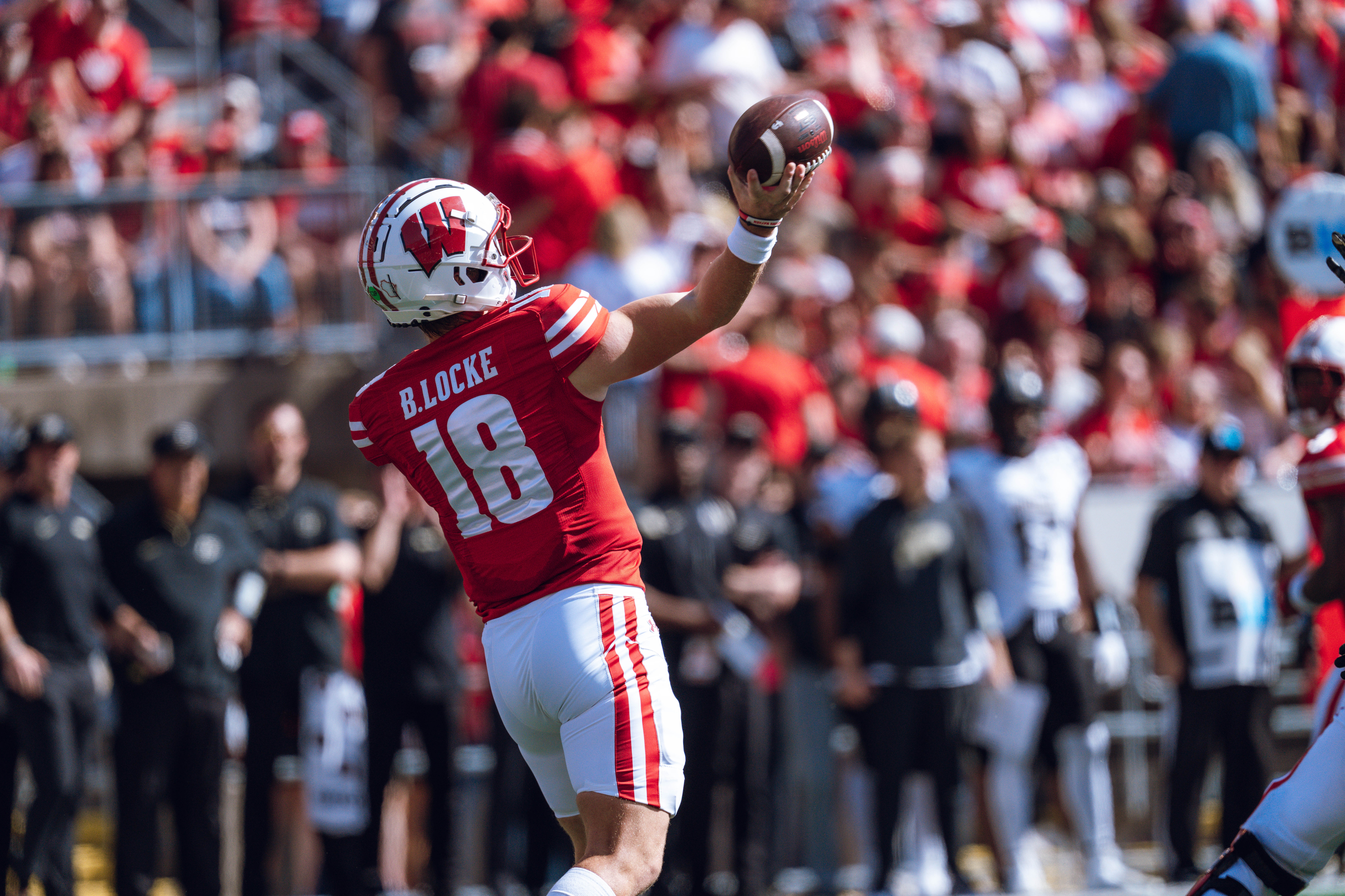 Wisconsin Badgers quarterback Braedyn Locke #18 throws a pass against the Purdue Boilermakers at Camp Randall Stadium on October 5, 2024 in Madison, Wisconsin. Photography by Ross Harried for Second Crop Sports.