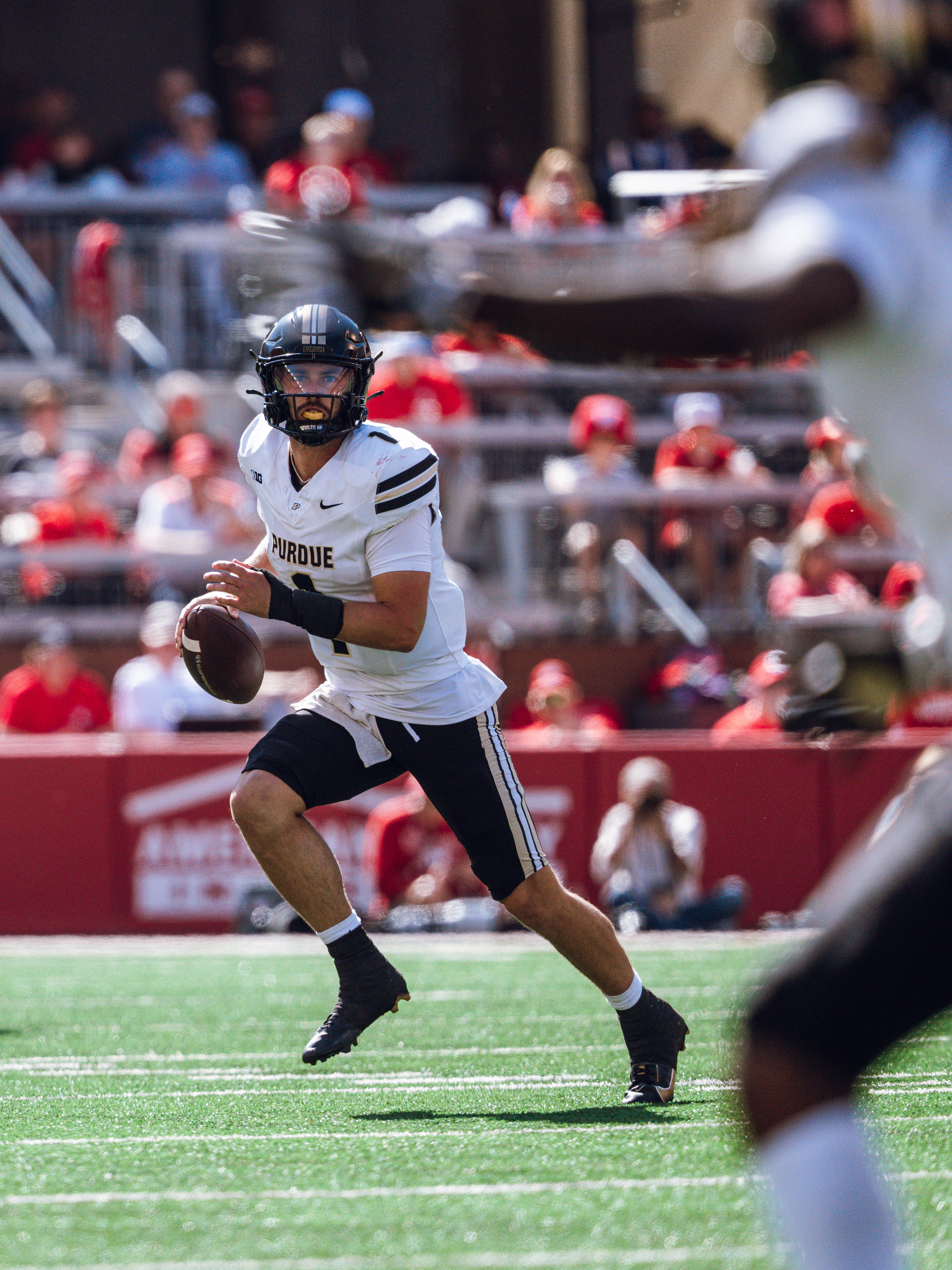 Purdue Boilermakers quarterback Hudson Card #1 looks down field for an open receiver against the Wisconsin Badgers at Camp Randall Stadium on October 5, 2024 in Madison, Wisconsin. Photography by Ross Harried for Second Crop Sports.