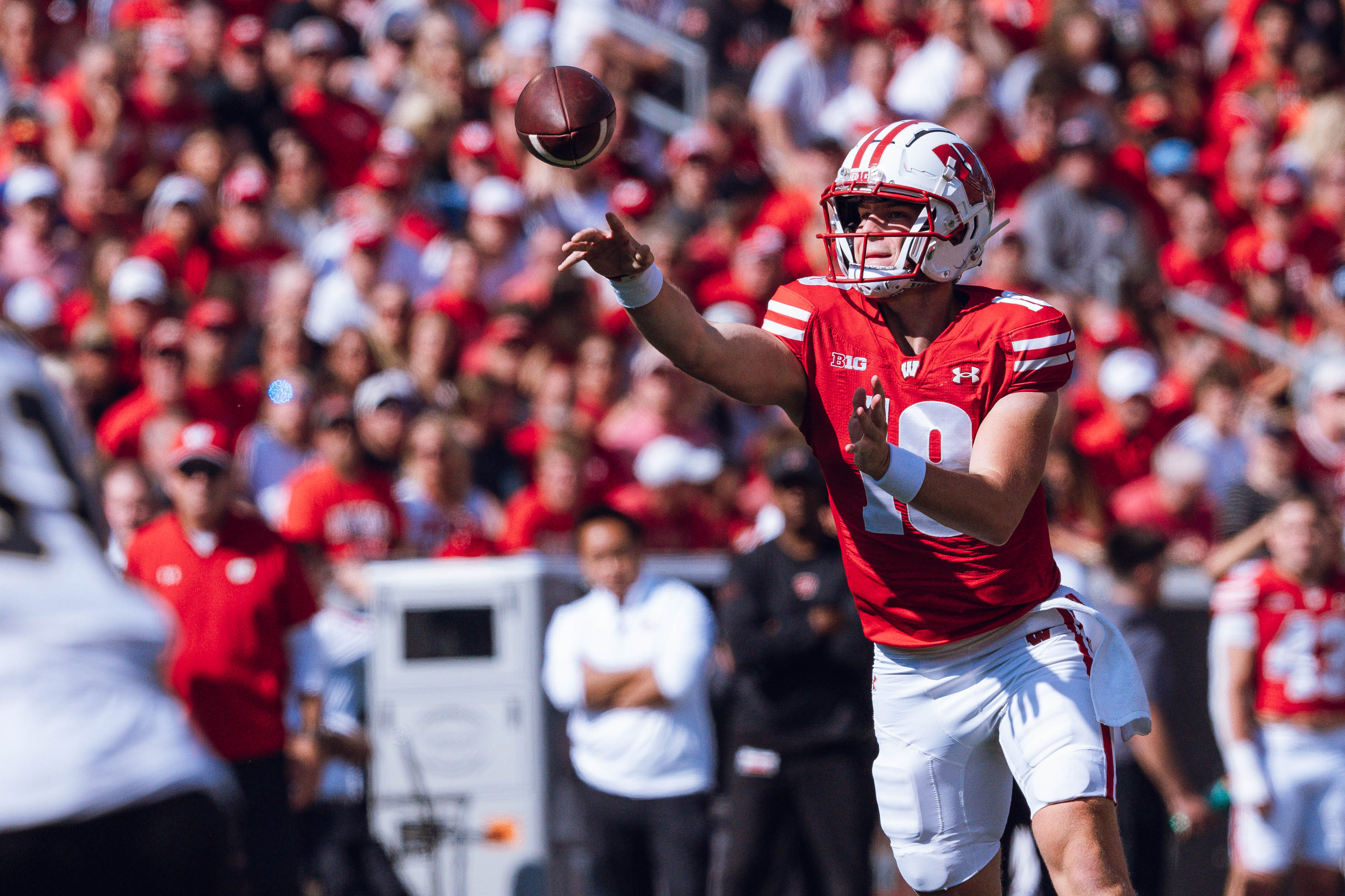 Wisconsin Badgers quarterback Braedyn Locke #18 throws a pass while on the run against the Purdue Boilermakers at Camp Randall Stadium on October 5, 2024 in Madison, Wisconsin. Photography by Ross Harried for Second Crop Sports.