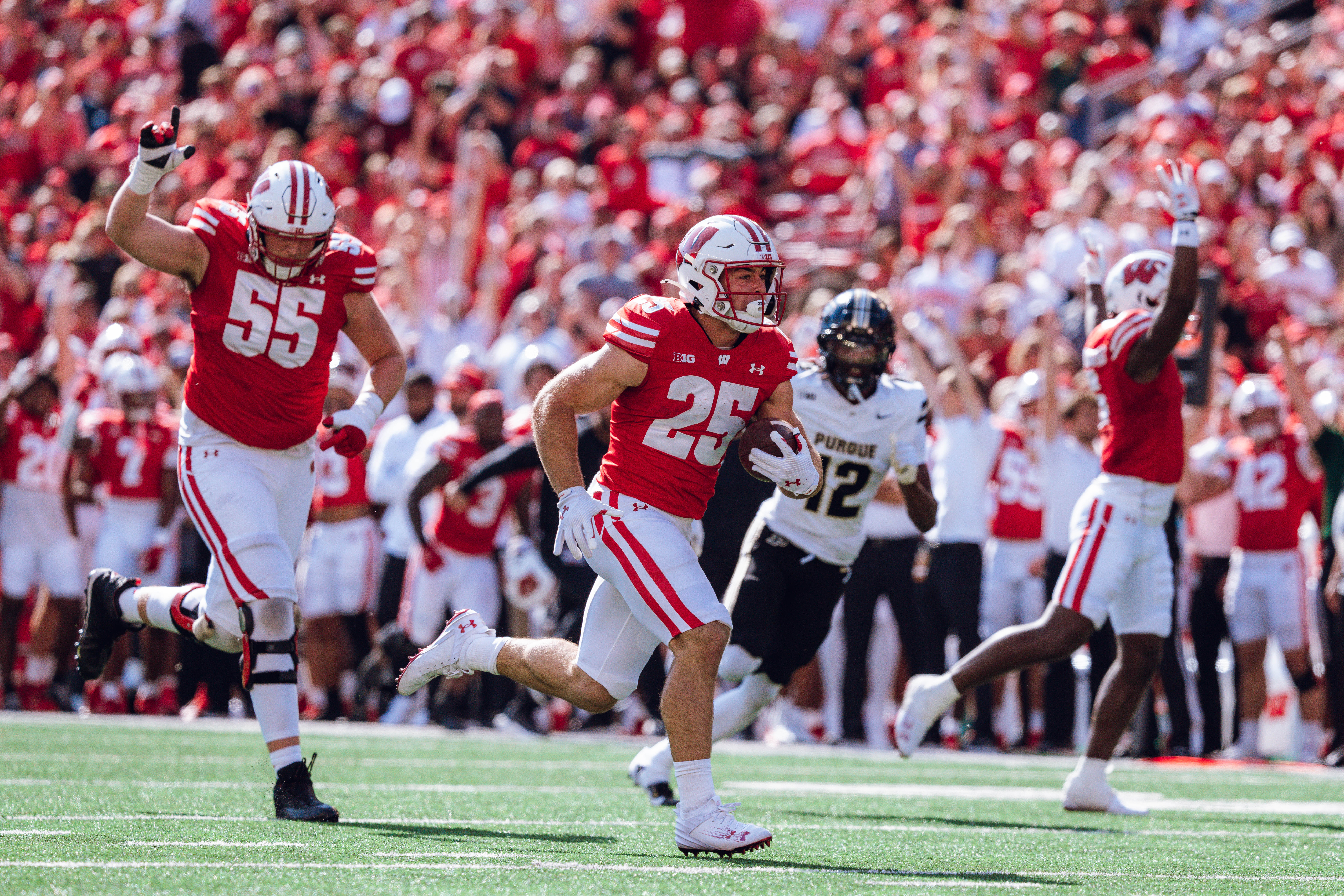 Wisconsin Badgers running back Cade Yacamelli #25 runs in a touchdown against the Purdue Boilermakers at Camp Randall Stadium on October 5, 2024 in Madison, Wisconsin. Photography by Ross Harried for Second Crop Sports.