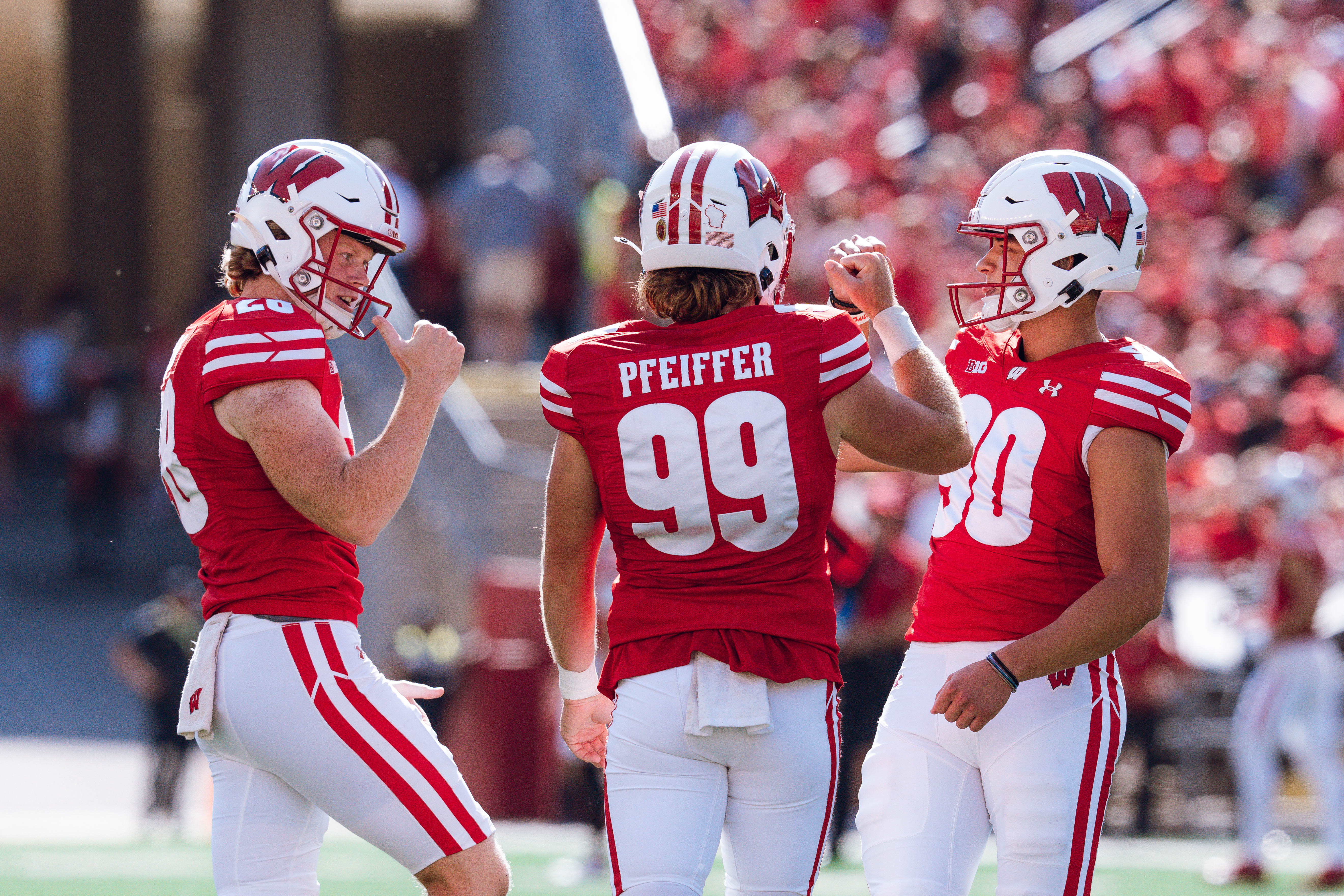 Wisconsin Badgers kicker Nathanial Vakos #90 celebrates with Cayson Pfeiffer #99 and Gavin Meyers #28 against the Purdue Boilermakers at Camp Randall Stadium on October 5, 2024 in Madison, Wisconsin. Photography by Ross Harried for Second Crop Sports.