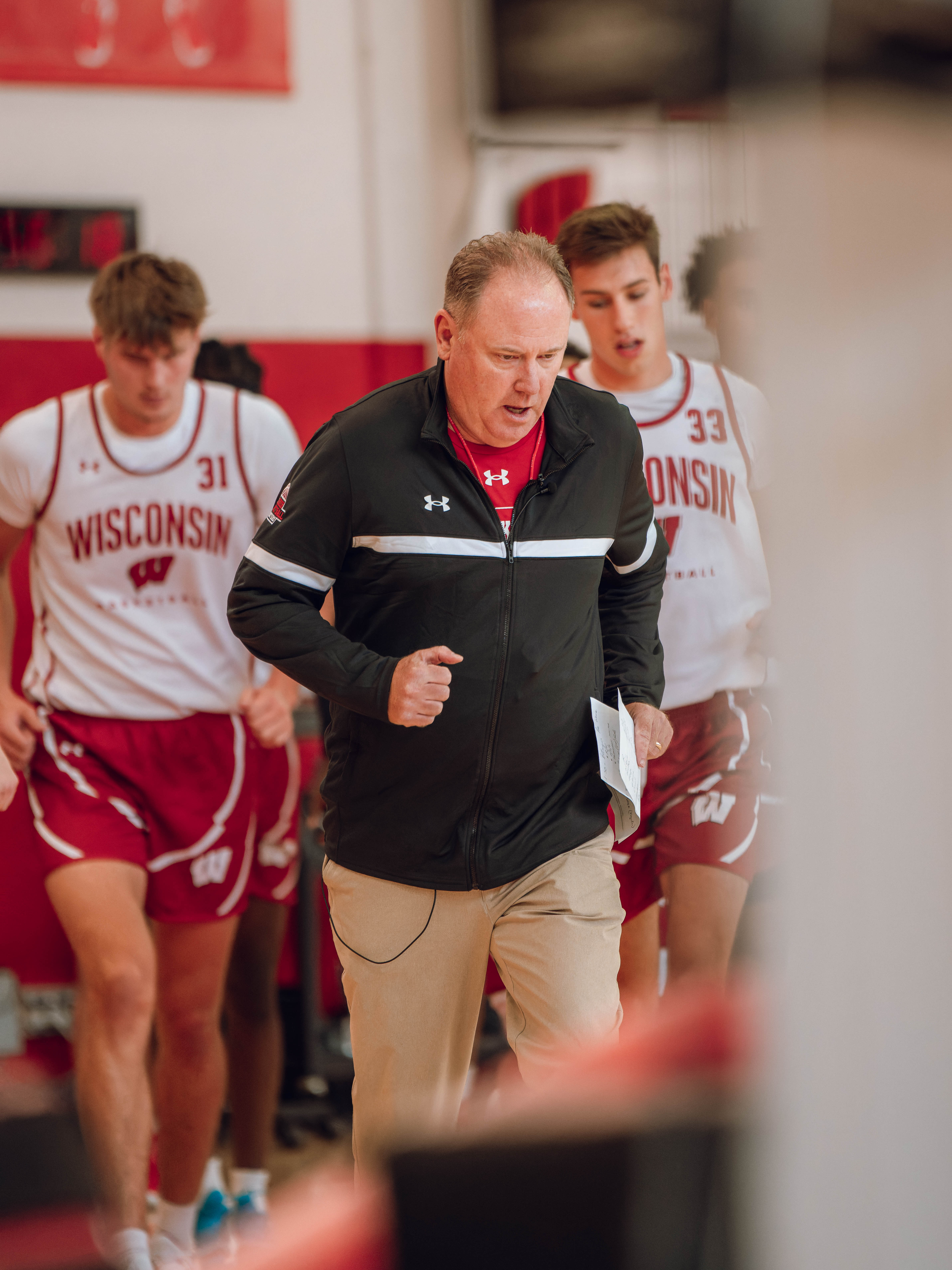 Wisconsin Badgers Head Coach Greg Gard leads the team onto the court during practice at the Nicholas Johnson Pavilion on October 7, 2024 in Madison, WI. Photography by Ross Harried for Second Crop Sports.