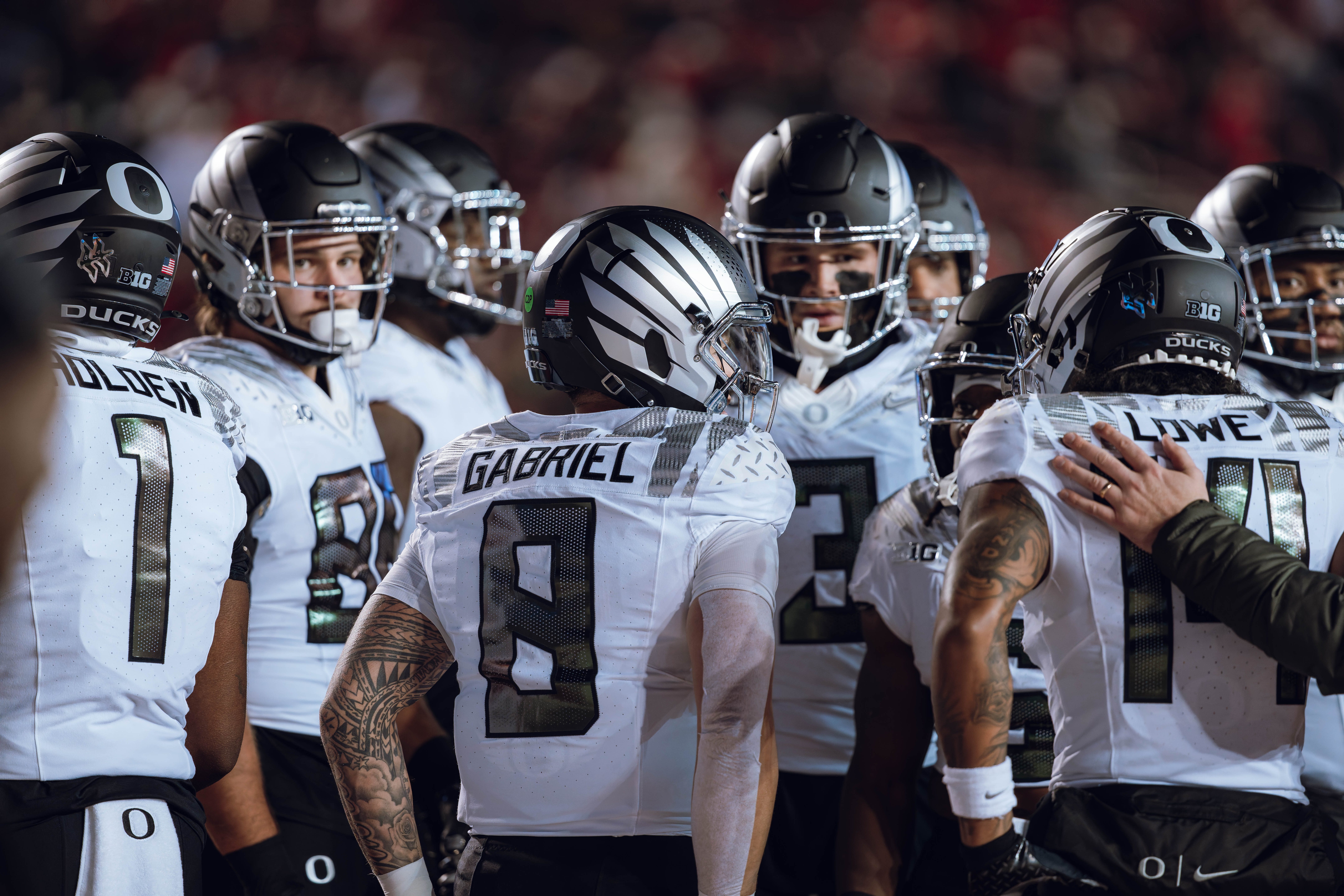 Oregon quarterback Dillon Gabriel #8 rallies the Oregon Ducks as they take on the Wisconsin Badgers at Camp Randall Stadium on November 16, 2024 in Madison, Wisconsin. Photography by Ross Harried for Second Crop Sports.