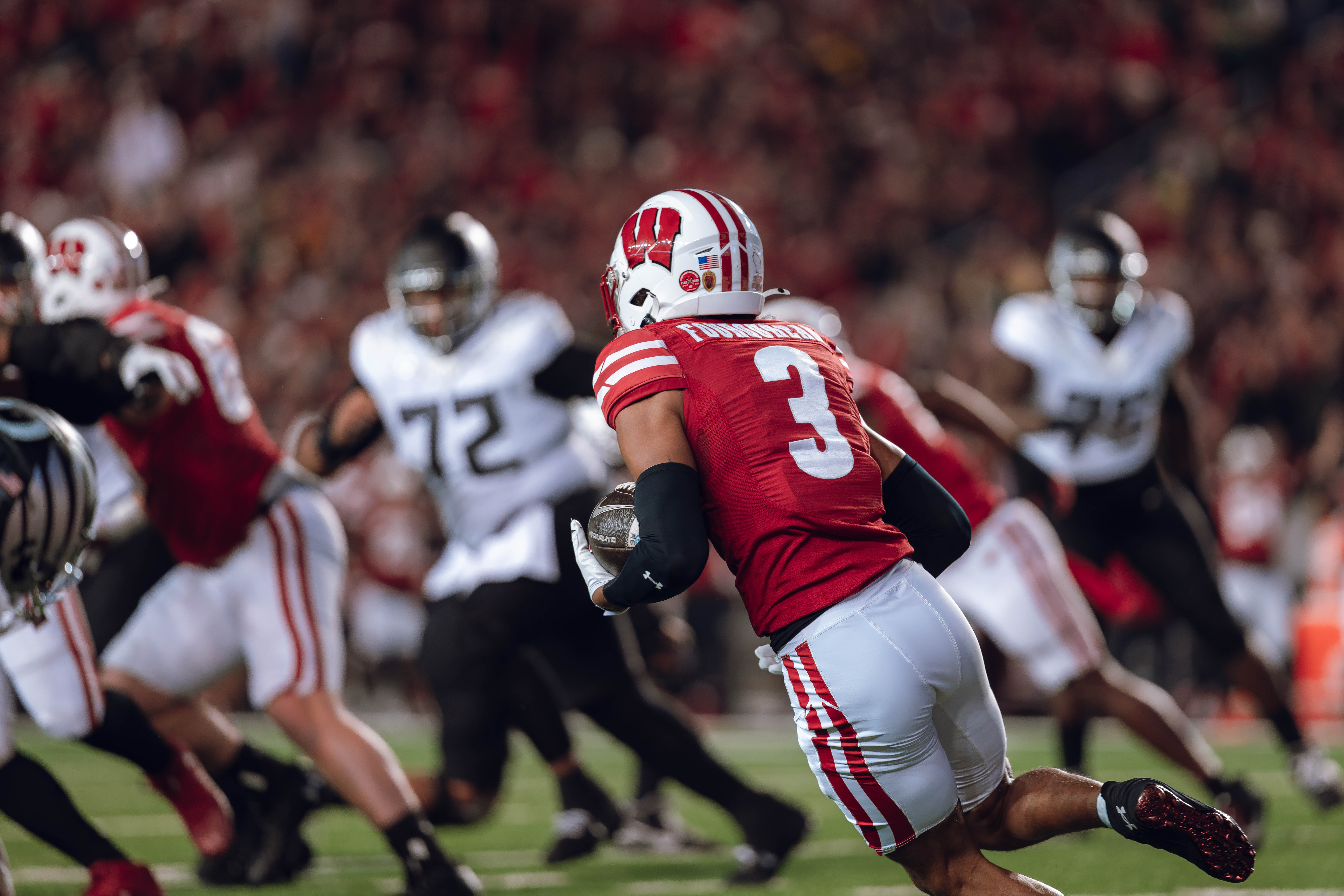 Wisconsin Badgers cornerback Nyzier Fourqurean #3 runs down field after intercepting a pass against the Oregon Ducks at Camp Randall Stadium on November 16, 2024 in Madison, Wisconsin. Photography by Ross Harried for Second Crop Sports.