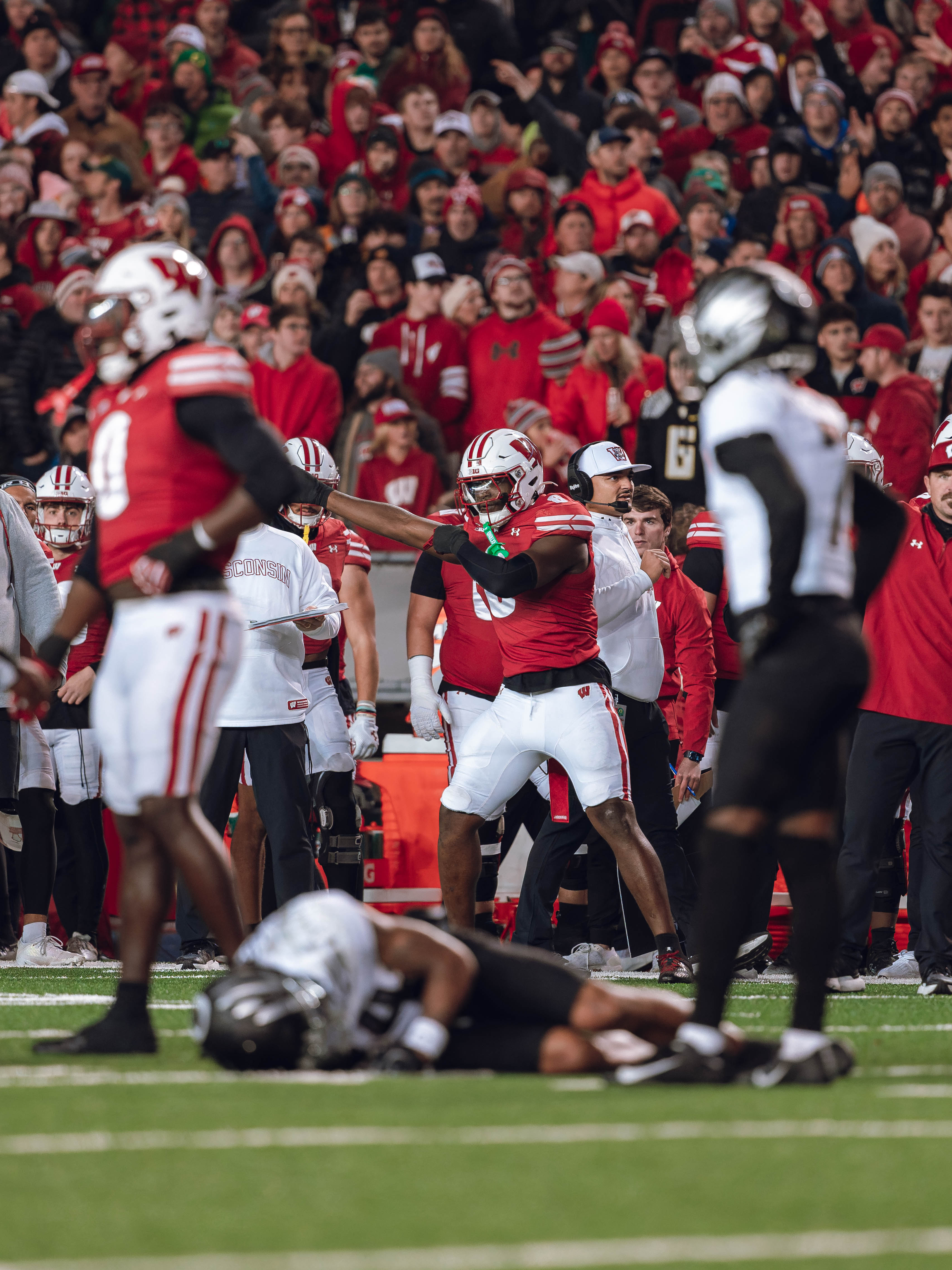 Wisconsin Badgers outside linebacker Leon Lowery Jr. #8 signals a turnover against The Oregon Ducks at Camp Randall Stadium on November 16, 2024 in Madison, Wisconsin. Photography by Ross Harried for Second Crop Sports.