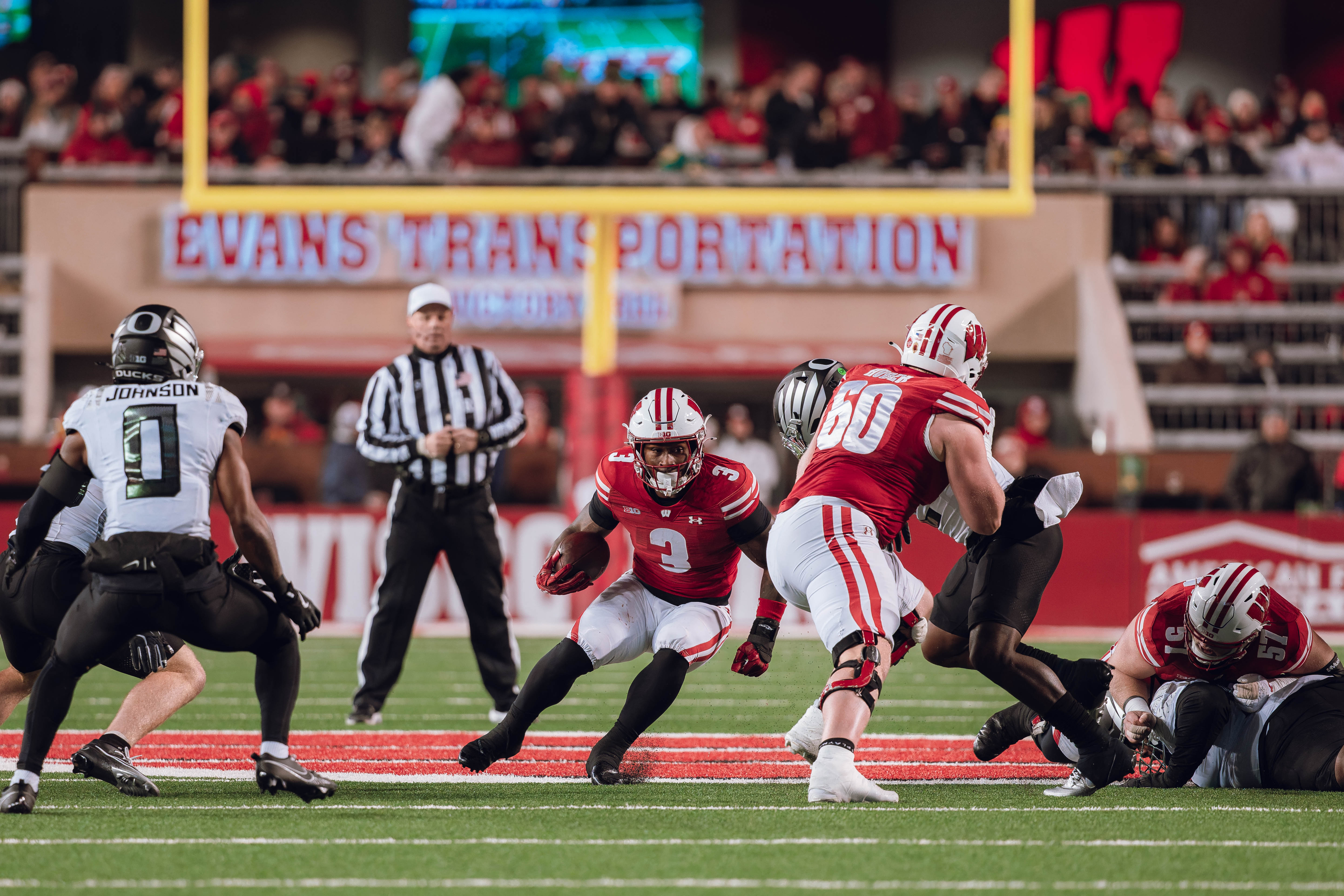 Wisconsin Badgers running back Tawee Walker #3 hits a hole with the help from Wisconsin Badgers offensive lineman Joe Huber #60 against the Oregon Ducks at Camp Randall Stadium on November 16, 2024 in Madison, Wisconsin. Photography by Ross Harried for Second Crop Sports.