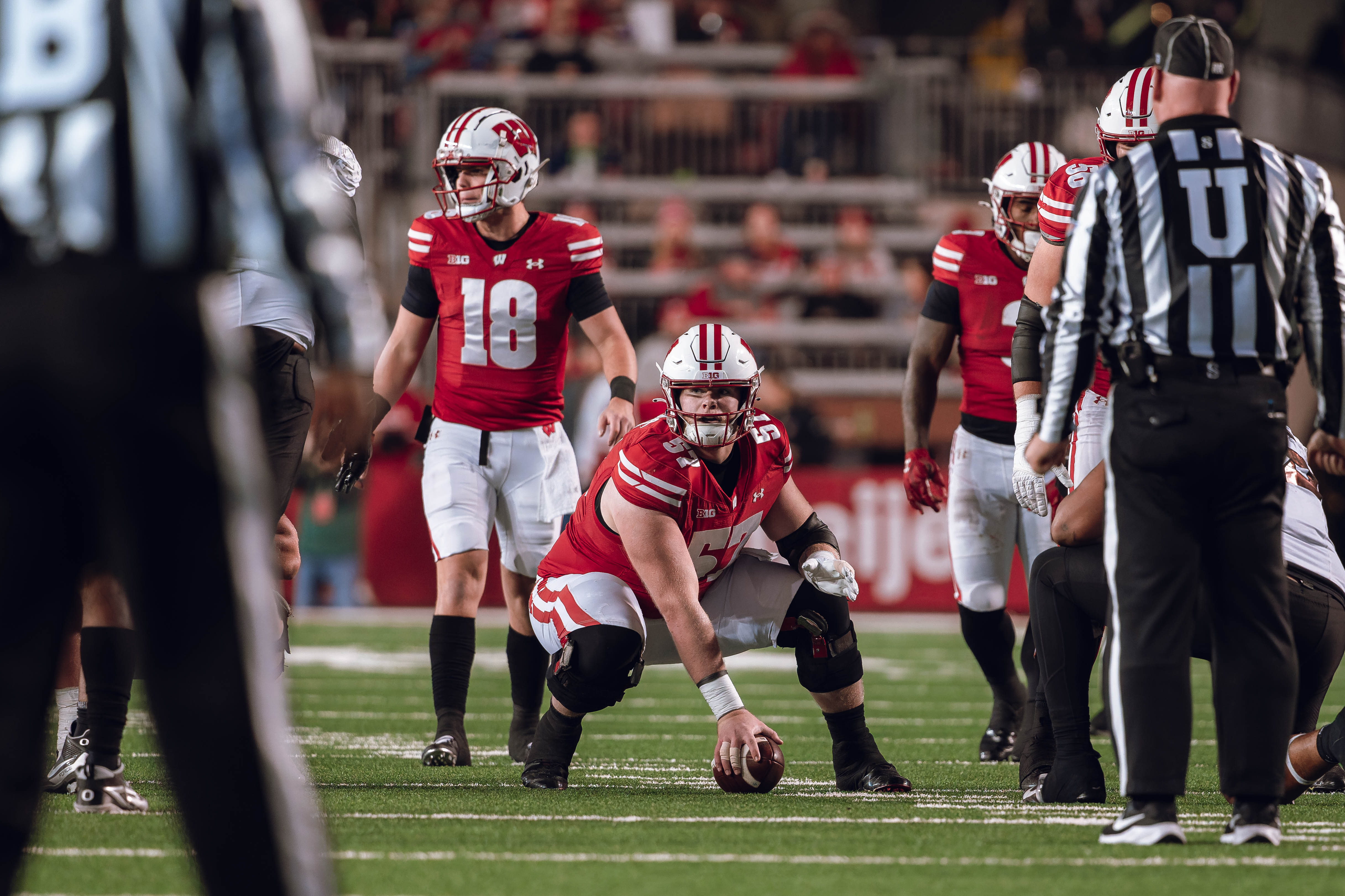 Wisconsin Badgers quarterback Braedyn Locke #18 and Wisconsin Badgers offensive lineman Jake Renfro #57 read the Oregon defense before the snap at Camp Randall Stadium on November 16, 2024 in Madison, Wisconsin. Photography by Ross Harried for Second Crop Sports.