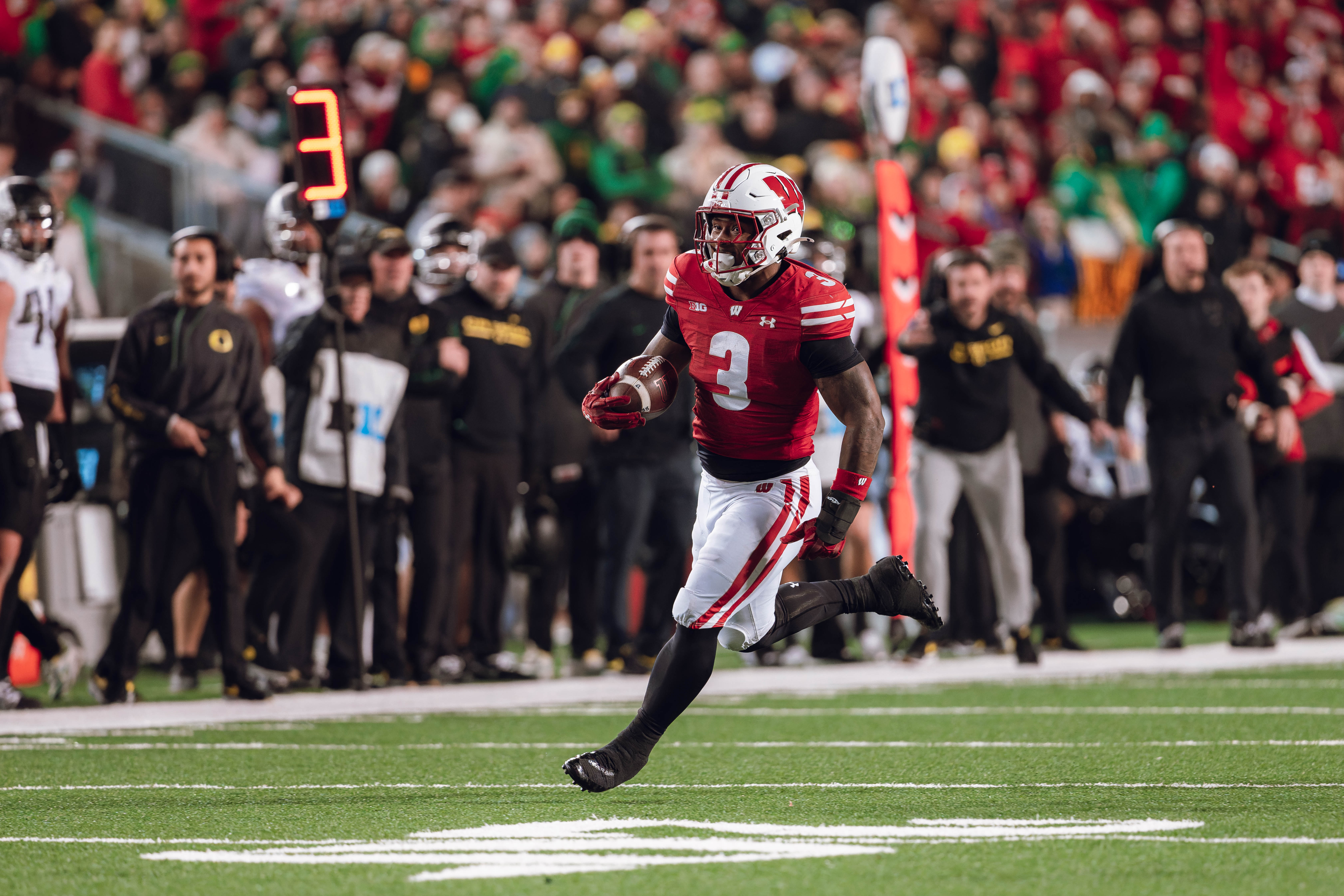 Wisconsin Badgers running back Tawee Walker #3 finds a seam on the edge against the Oregon Ducks at Camp Randall Stadium on November 16, 2024 in Madison, Wisconsin. Photography by Ross Harried for Second Crop Sports.