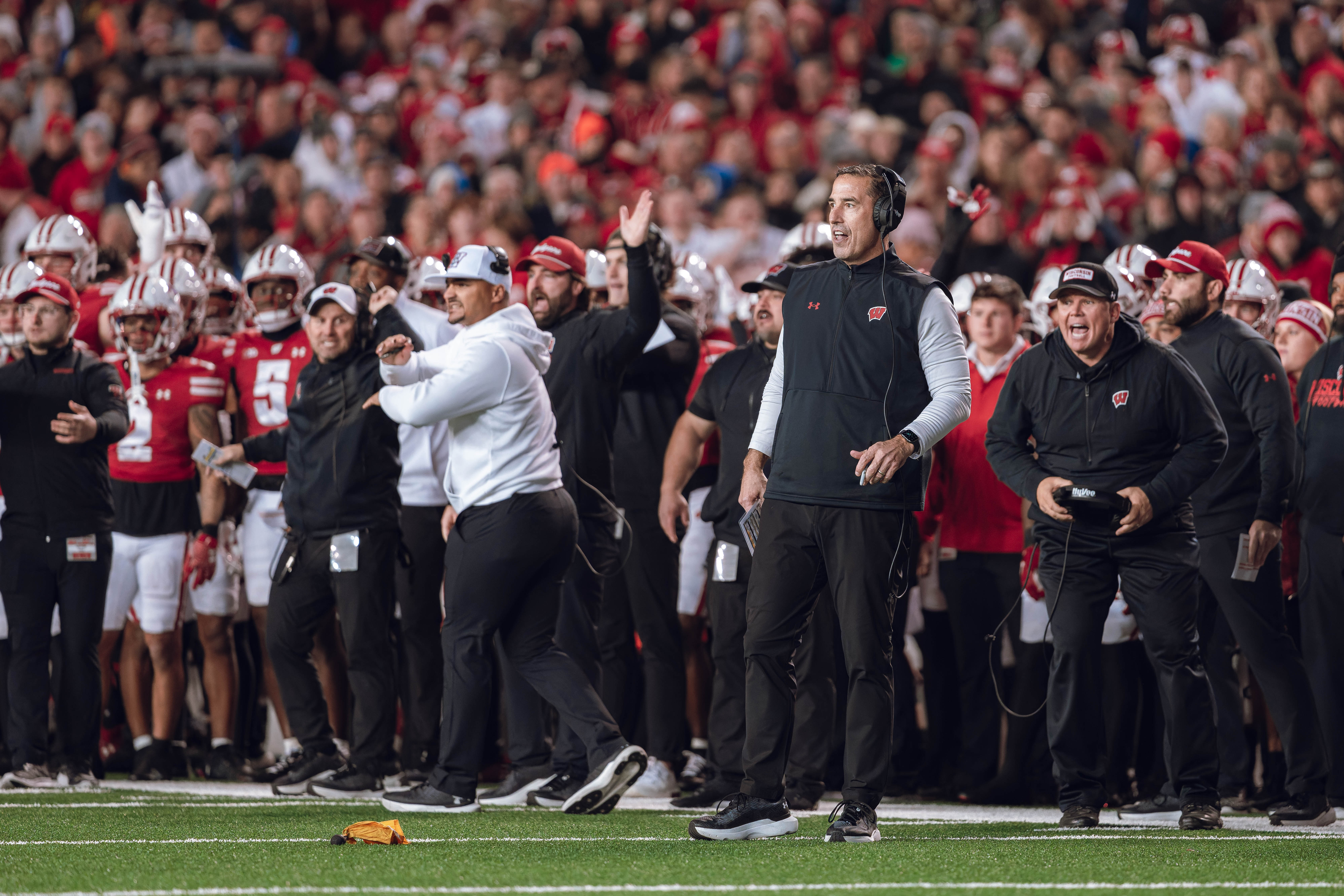 Wisconsin Badgers Head Coach Luke Fickell and the Wisconsin Badgers sideline react to a penalty as they take on the Oregon Ducks at Camp Randall Stadium on November 16, 2024 in Madison, Wisconsin. Photography by Ross Harried for Second Crop Sports.