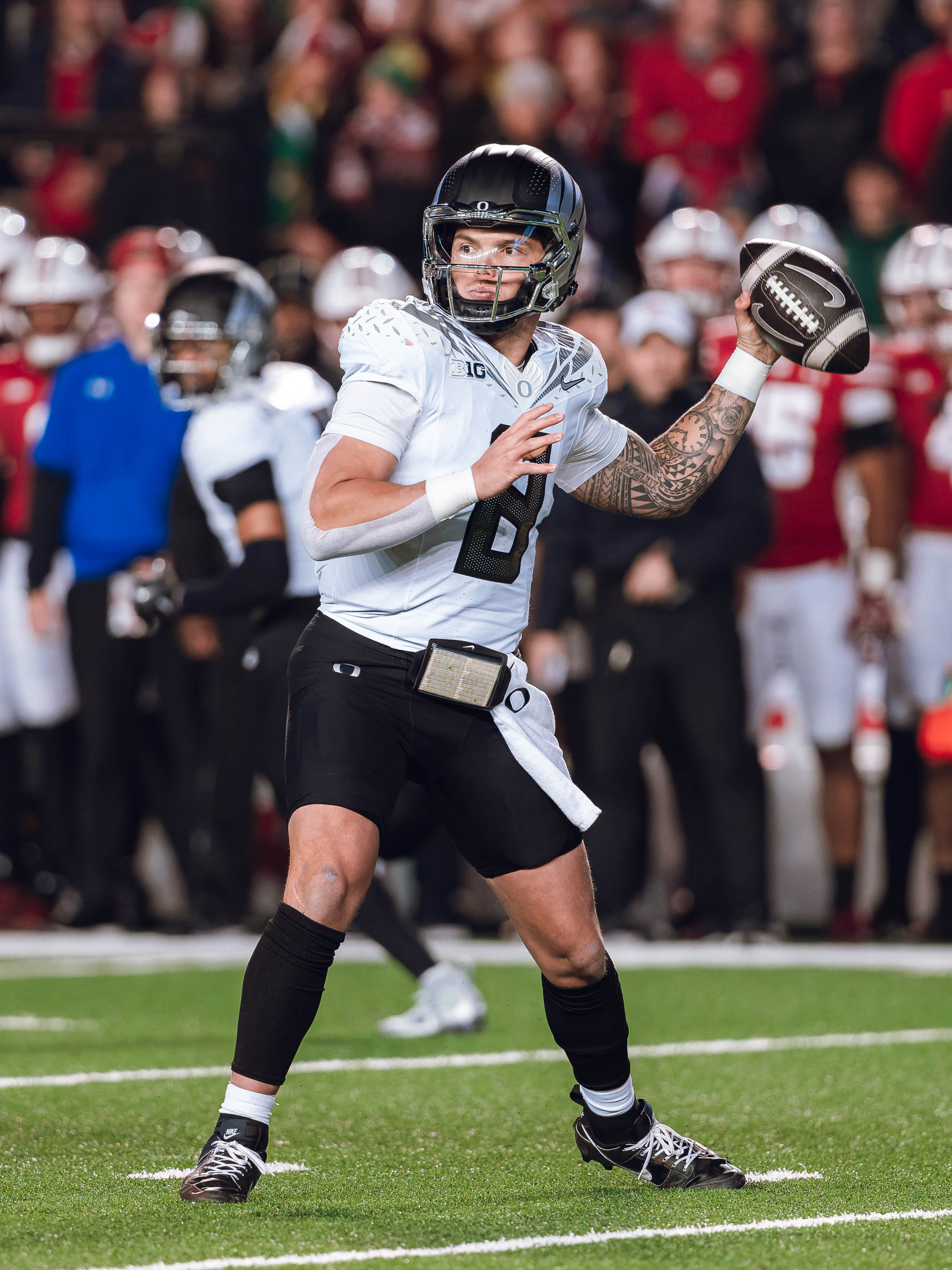 Oregon quarterback Dillon Gabriel #8 throws a pass against the Wisconsin Badgers at Camp Randall Stadium on November 16, 2024 in Madison, Wisconsin. Photography by Ross Harried for Second Crop Sports.