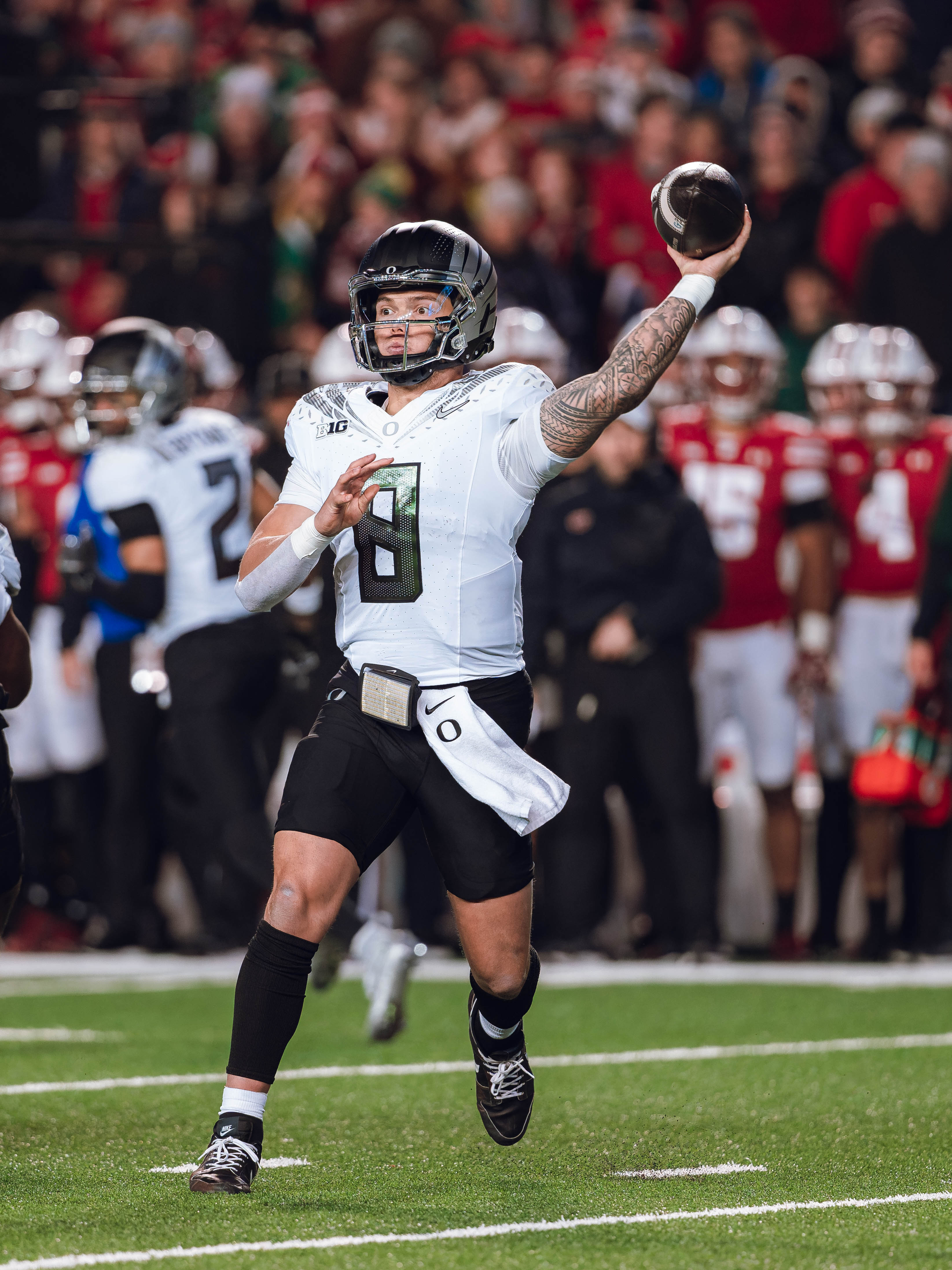 Oregon quarterback Dillon Gabriel #8 throws a pass against the Wisconsin Badgers at Camp Randall Stadium on November 16, 2024 in Madison, Wisconsin. Photography by Ross Harried for Second Crop Sports.