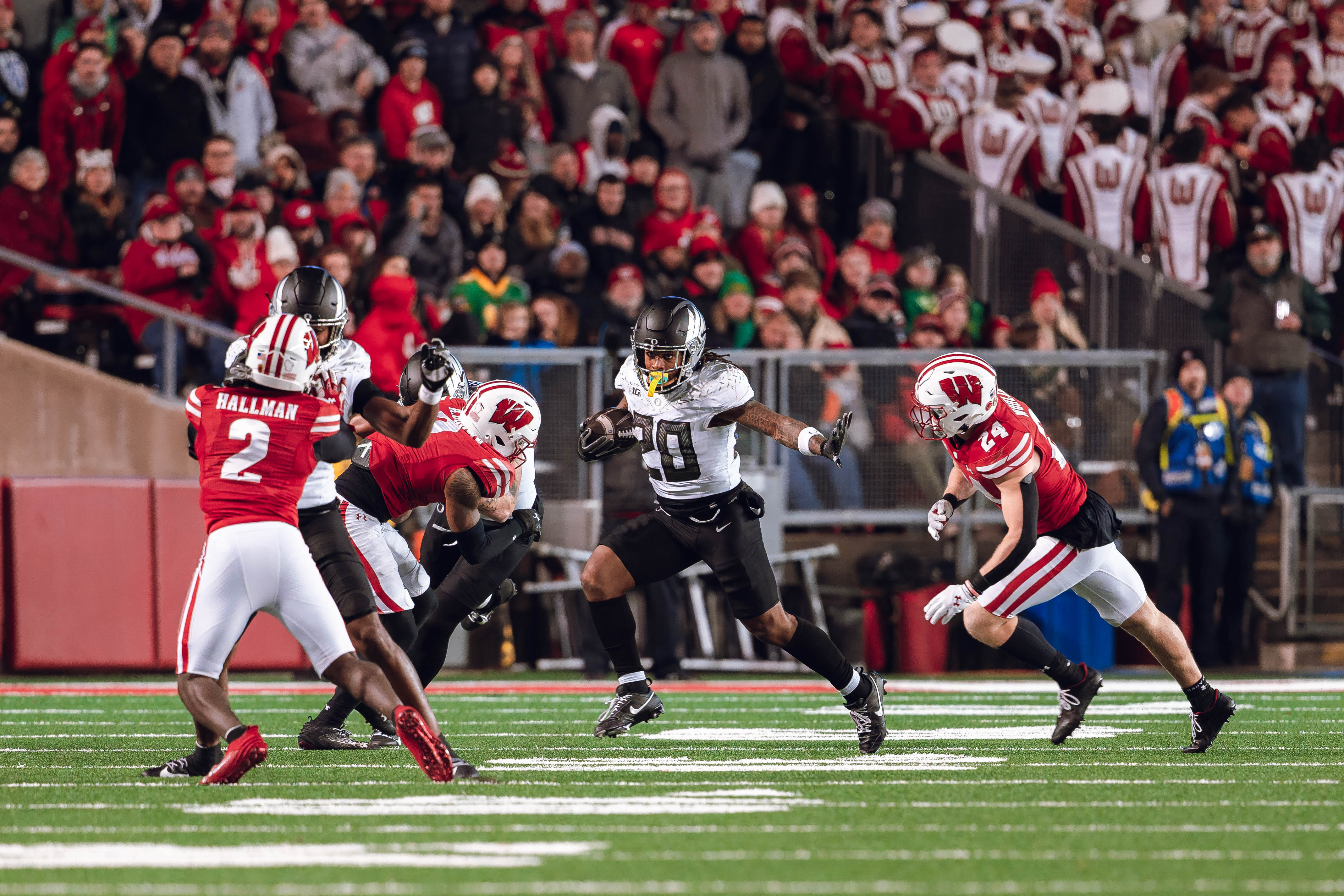 Oregon running back Jordan James #20 gives a stiff arm against the Wisconsin Badgers at Camp Randall Stadium on November 16, 2024 in Madison, Wisconsin. Photography by Ross Harried for Second Crop Sports.