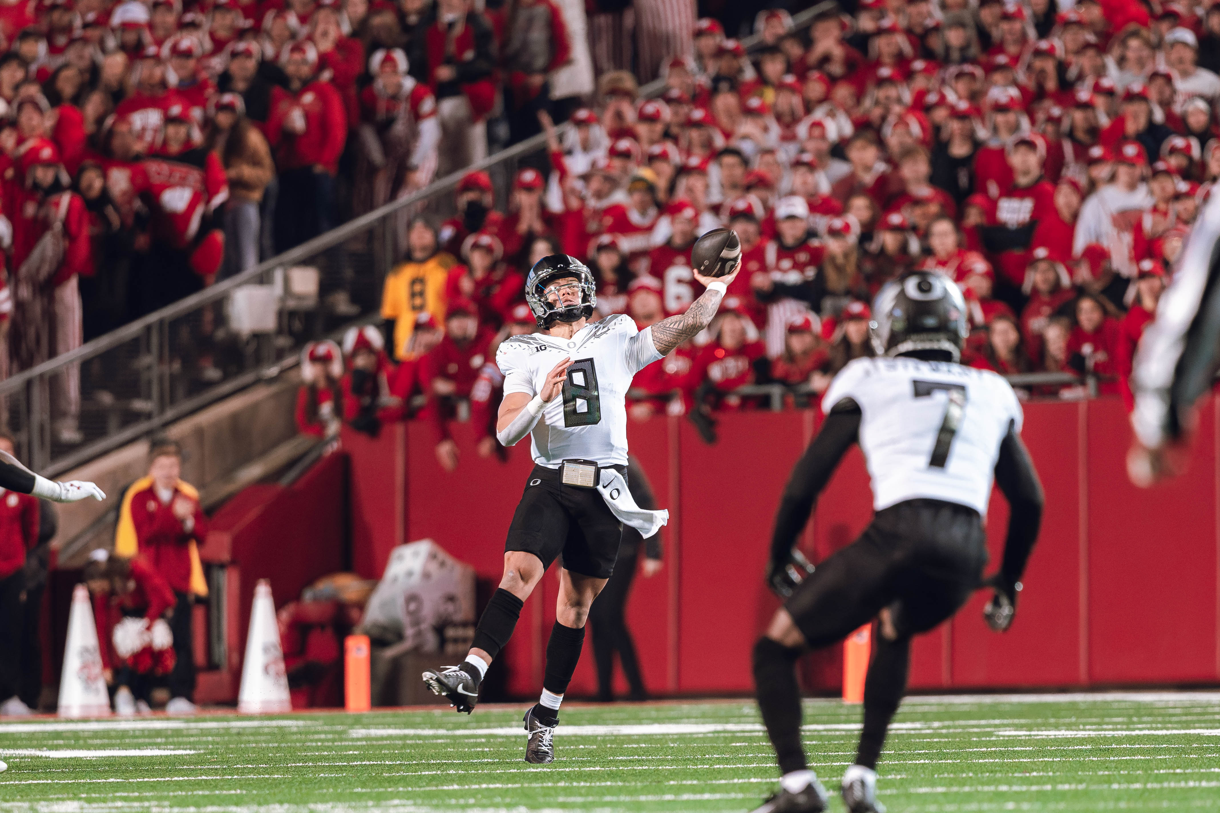 Oregon quarterback Dillon Gabriel #8 heaves a pass down field against the Wisconsin Badgers at Camp Randall Stadium on November 16, 2024 in Madison, Wisconsin. Photography by Ross Harried for Second Crop Sports.