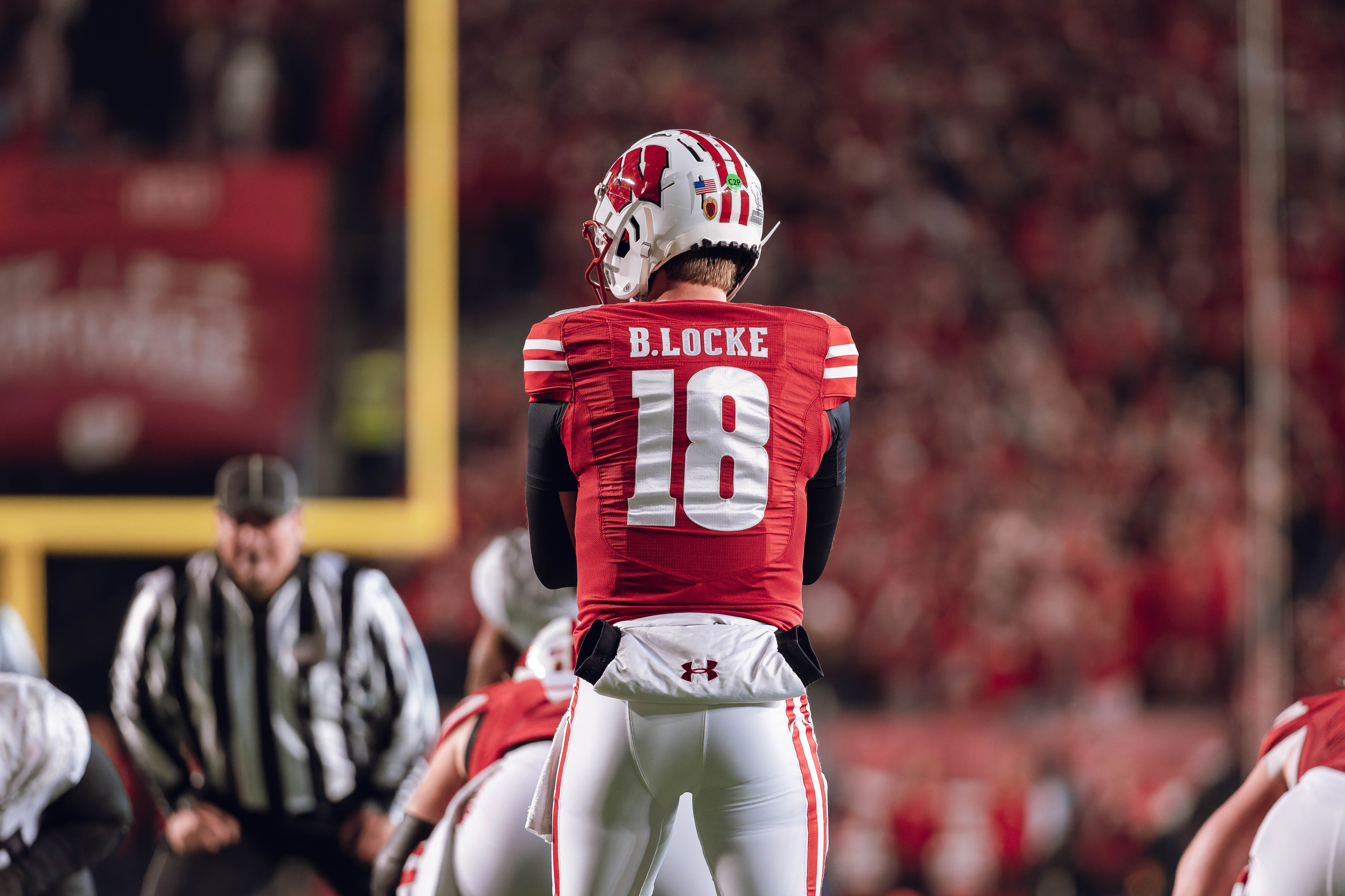 Wisconsin Badgers quarterback Braedyn Locke #18 eyes the Oregon Ducks defense before the snap at Camp Randall Stadium on November 16, 2024 in Madison, Wisconsin. Photography by Ross Harried for Second Crop Sports.