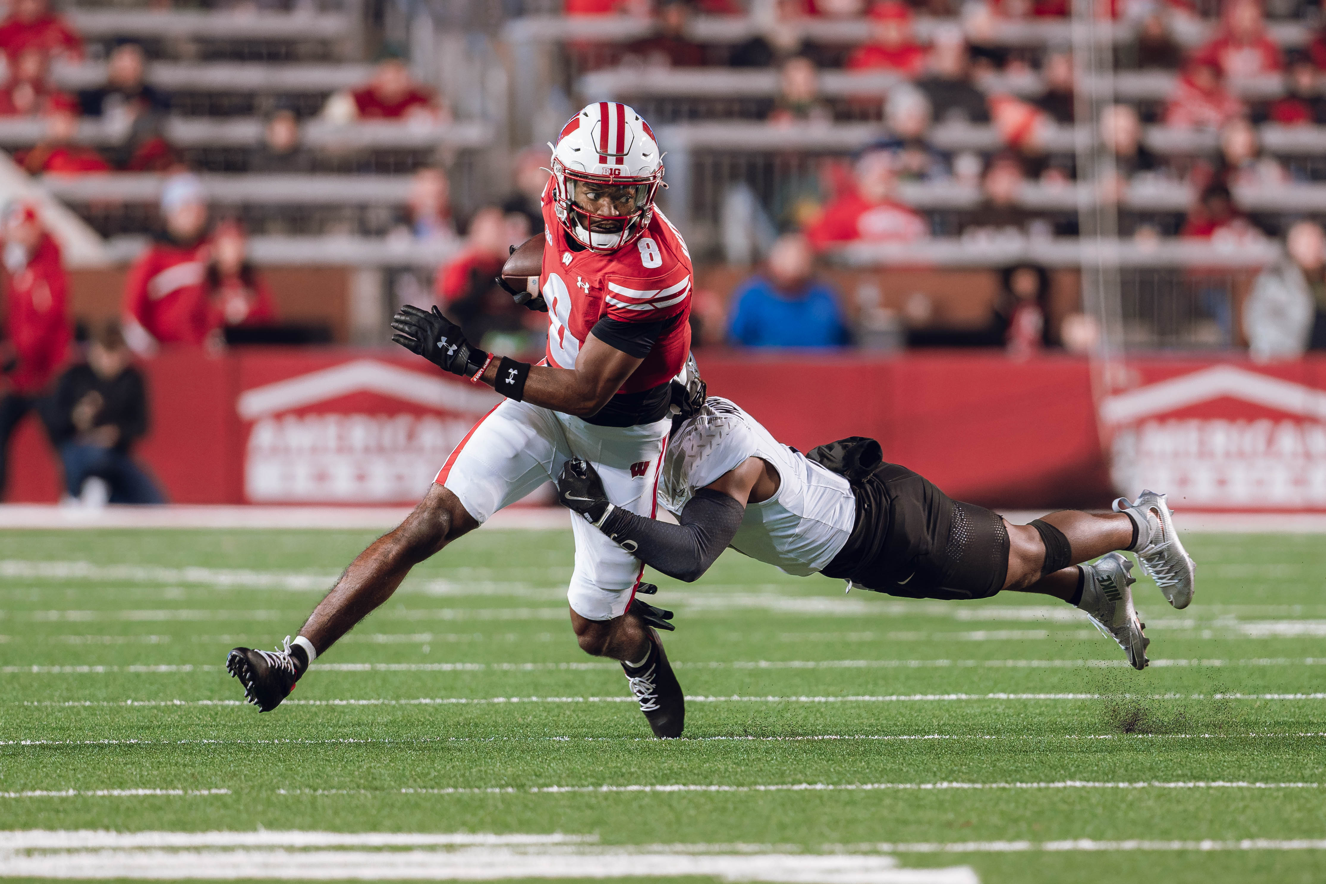 Wisconsin Badgers wide receiver Vinny Anthony II #8 tries to escape a tackle against the Oregon Ducks at Camp Randall Stadium on November 16, 2024 in Madison, Wisconsin. Photography by Ross Harried for Second Crop Sports.