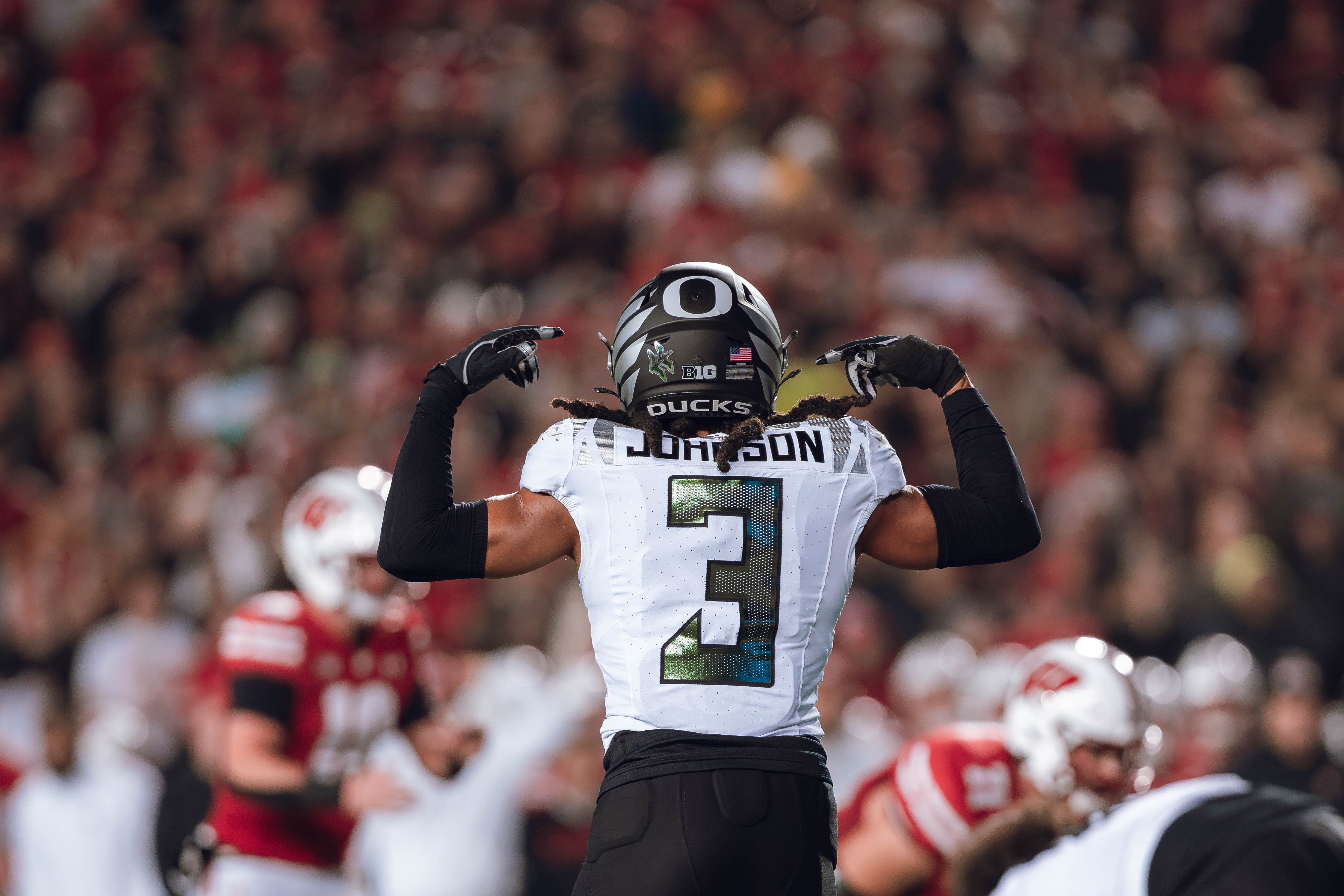 Oregon defensive back Brandon Johnson #3 communicates with his teammates against the Wisconsin Badgers at Camp Randall Stadium on November 16, 2024 in Madison, Wisconsin. Photography by Ross Harried for Second Crop Sports.