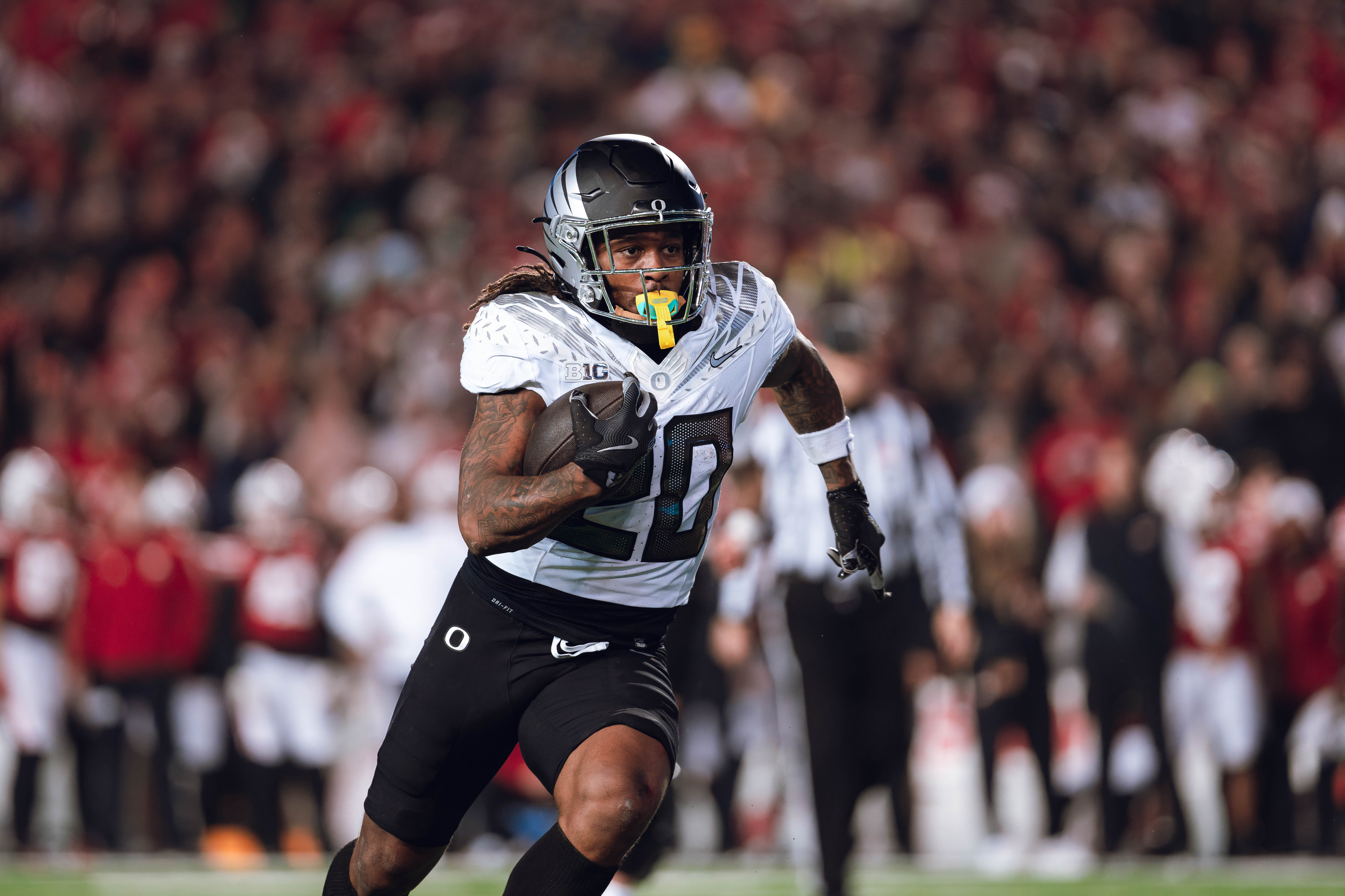 Oregon running back Jordan James #20 finds an opening on the edge for a touchdown against the Wisconsin Badgers at Camp Randall Stadium on November 16, 2024 in Madison, Wisconsin. Photography by Ross Harried for Second Crop Sports.