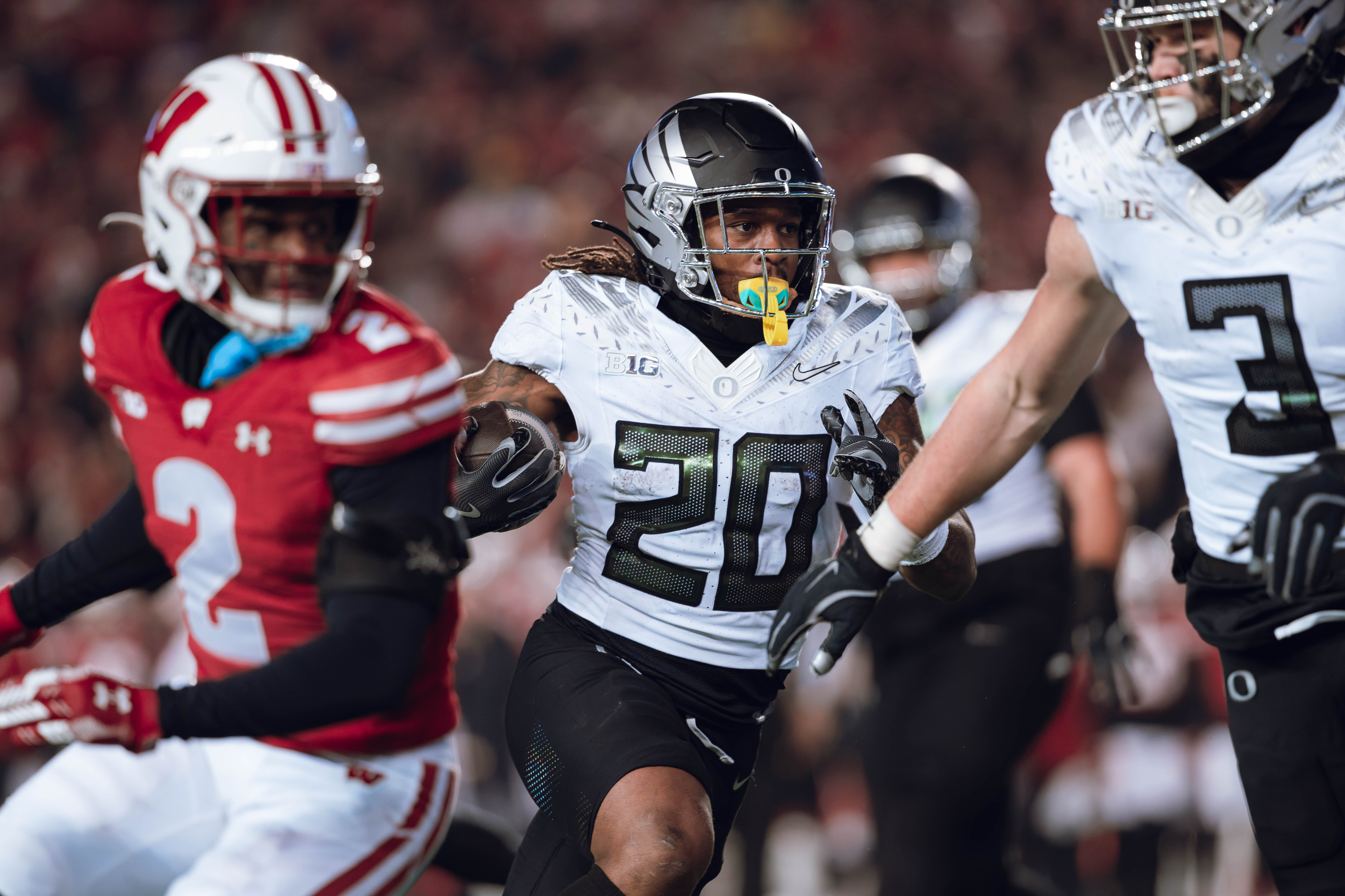 Oregon running back Jordan James #20 finds an opening on the edge for a touchdown against the Wisconsin Badgers at Camp Randall Stadium on November 16, 2024 in Madison, Wisconsin. Photography by Ross Harried for Second Crop Sports.