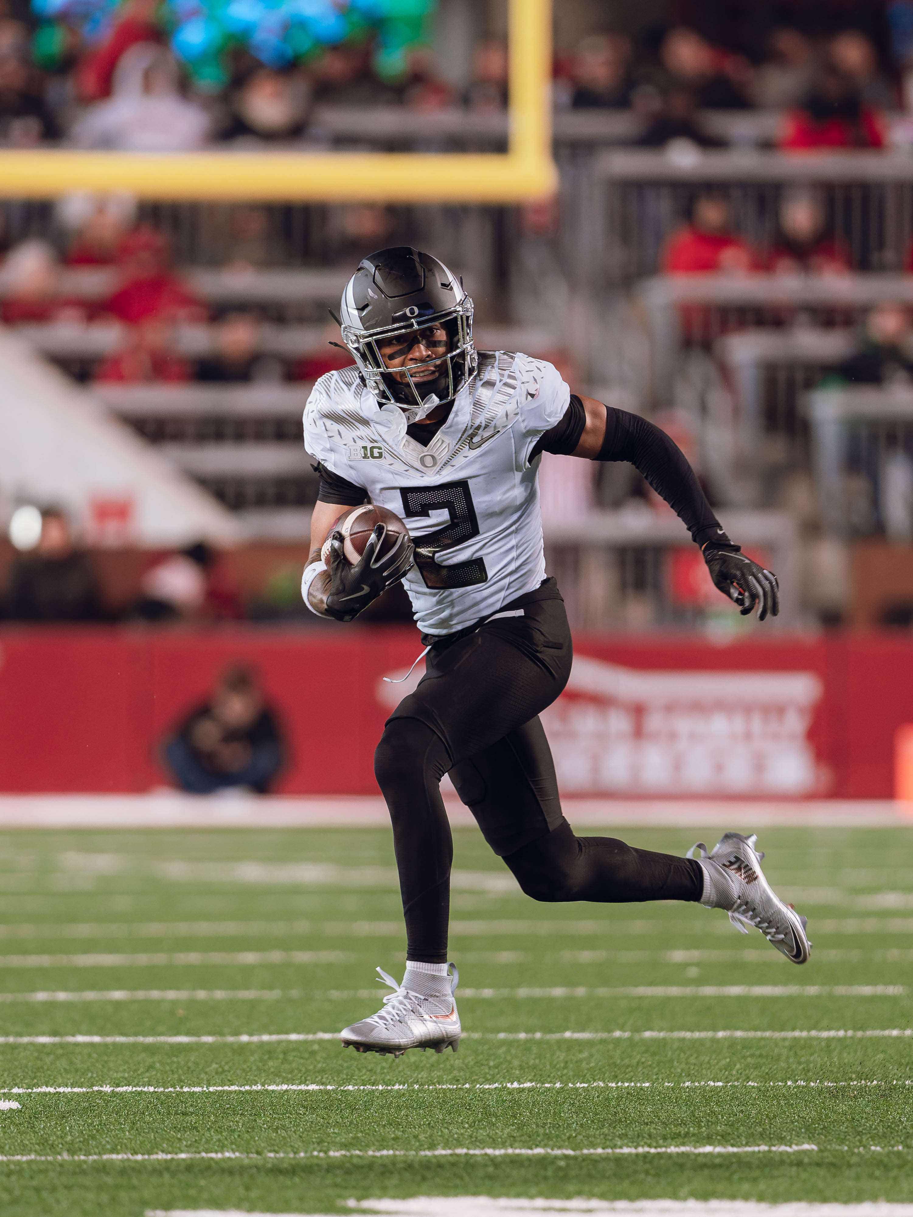 Oregon wide receiver Gary Bryant Jr. #2 runs the ball up field after a catch against the Wisconsin Badgers at Camp Randall Stadium on November 16, 2024 in Madison, Wisconsin. Photography by Ross Harried for Second Crop Sports.