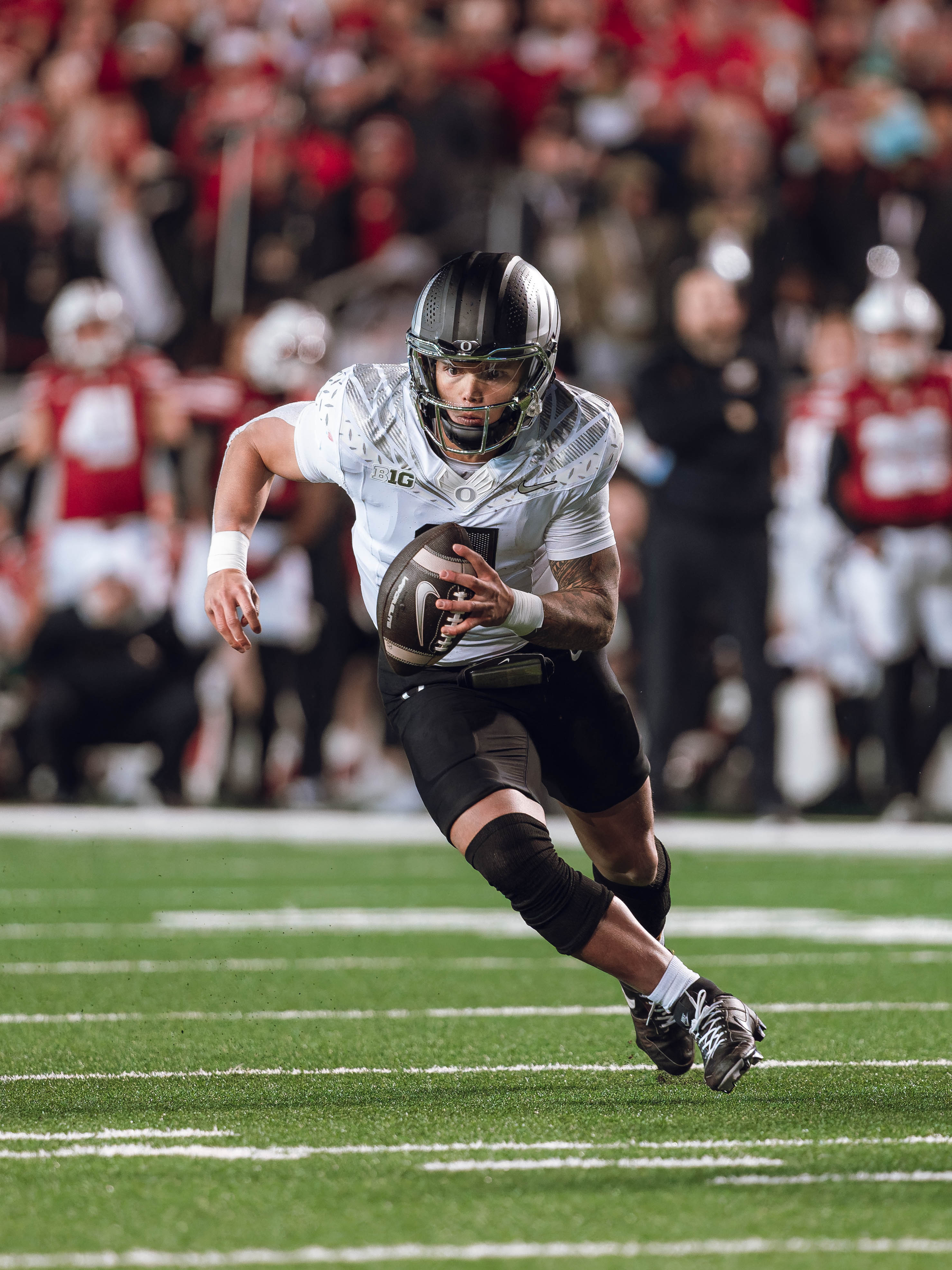 Oregon quarterback Dillon Gabriel #8 scrambles against the Wisconsin Badgers at Camp Randall Stadium on November 16, 2024 in Madison, Wisconsin. Photography by Ross Harried for Second Crop Sports.