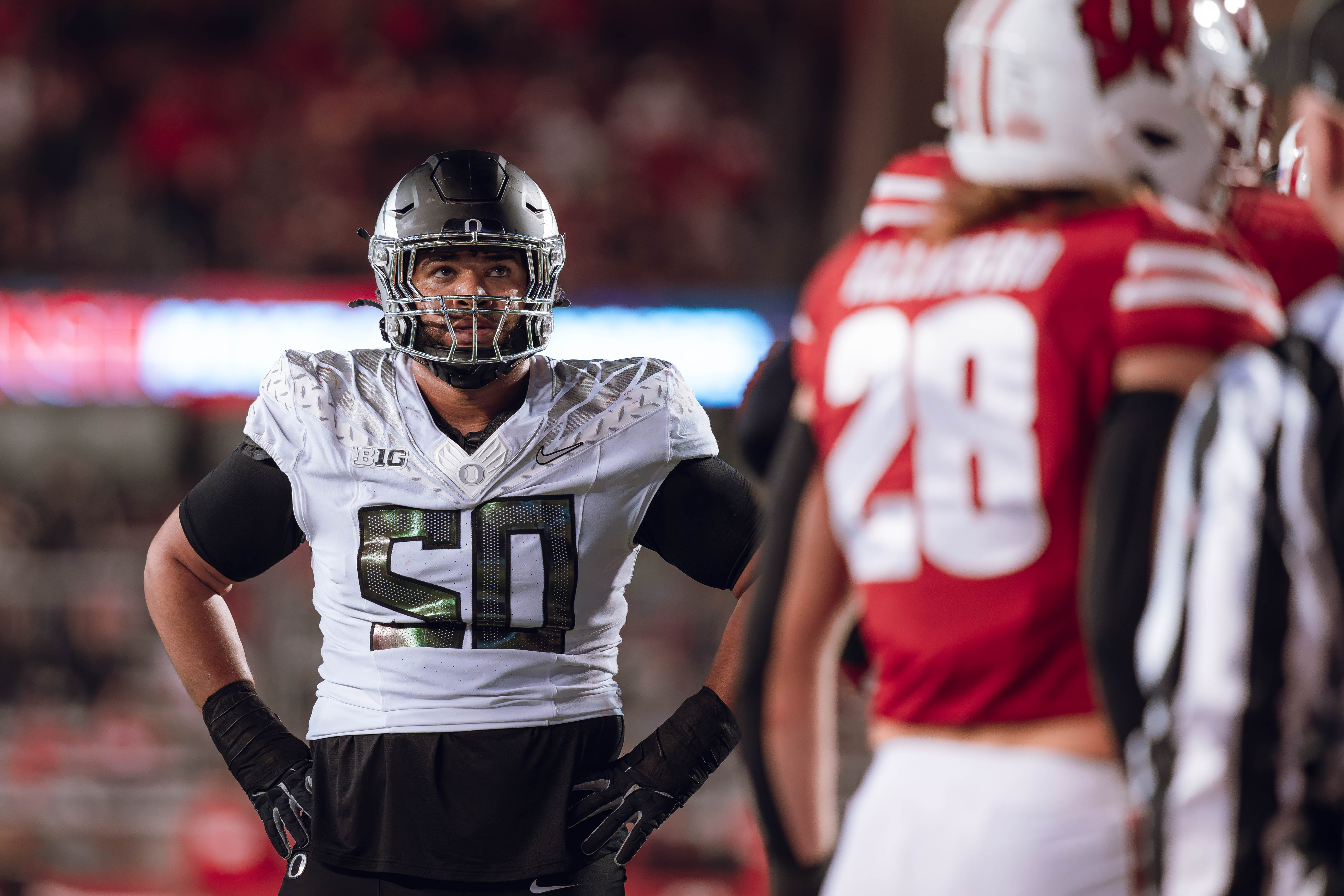 Oregon offensive lineman Nishad Strother #50 looks up at the clock in the 4th quarter against the Wisconsin Badgers at Camp Randall Stadium on November 16, 2024 in Madison, Wisconsin. Photography by Ross Harried for Second Crop Sports.