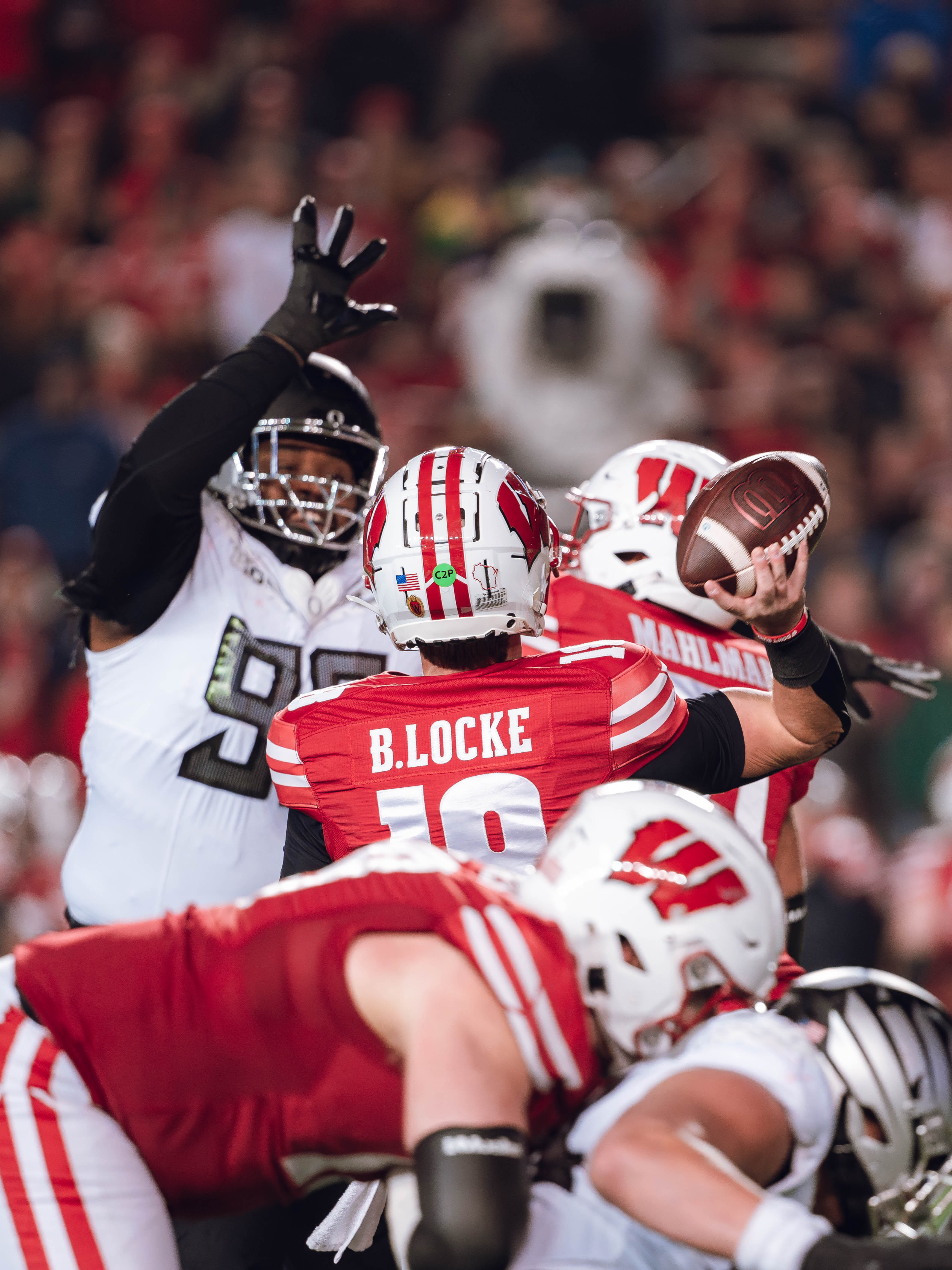 Wisconsin Badgers quarterback Braedyn Locke #18 attempts a pass against the Oregon Ducks at Camp Randall Stadium on November 16, 2024 in Madison, Wisconsin. Photography by Ross Harried for Second Crop Sports.