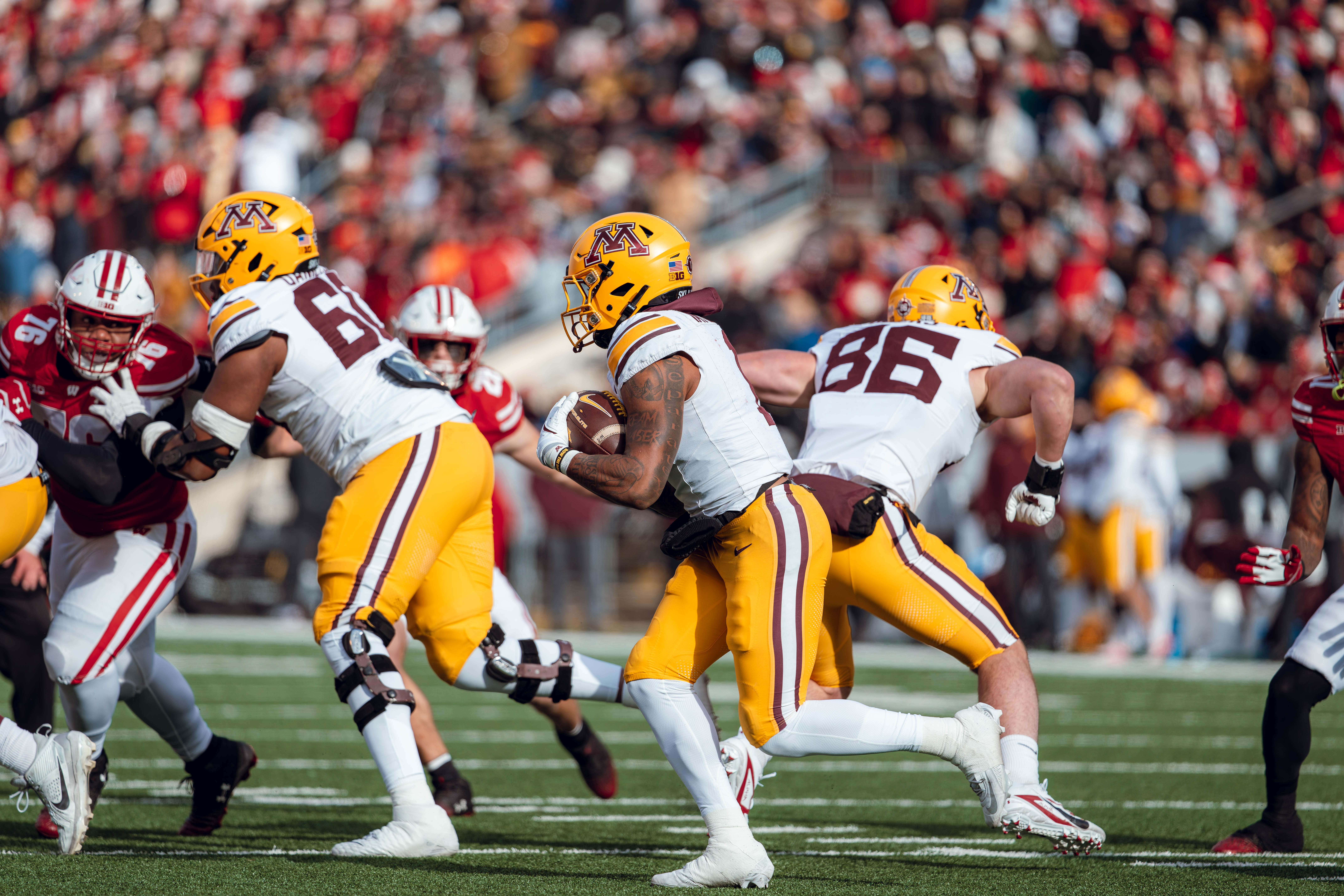 Minnesota Golden Gopher running back Darius Taylor #1 runs the ball against the Wisconsin Badgers defense at Camp Randall Stadium on November 29, 2024 in Madison, Wisconsin. Photography by Ross Harried for Second Crop Sports.