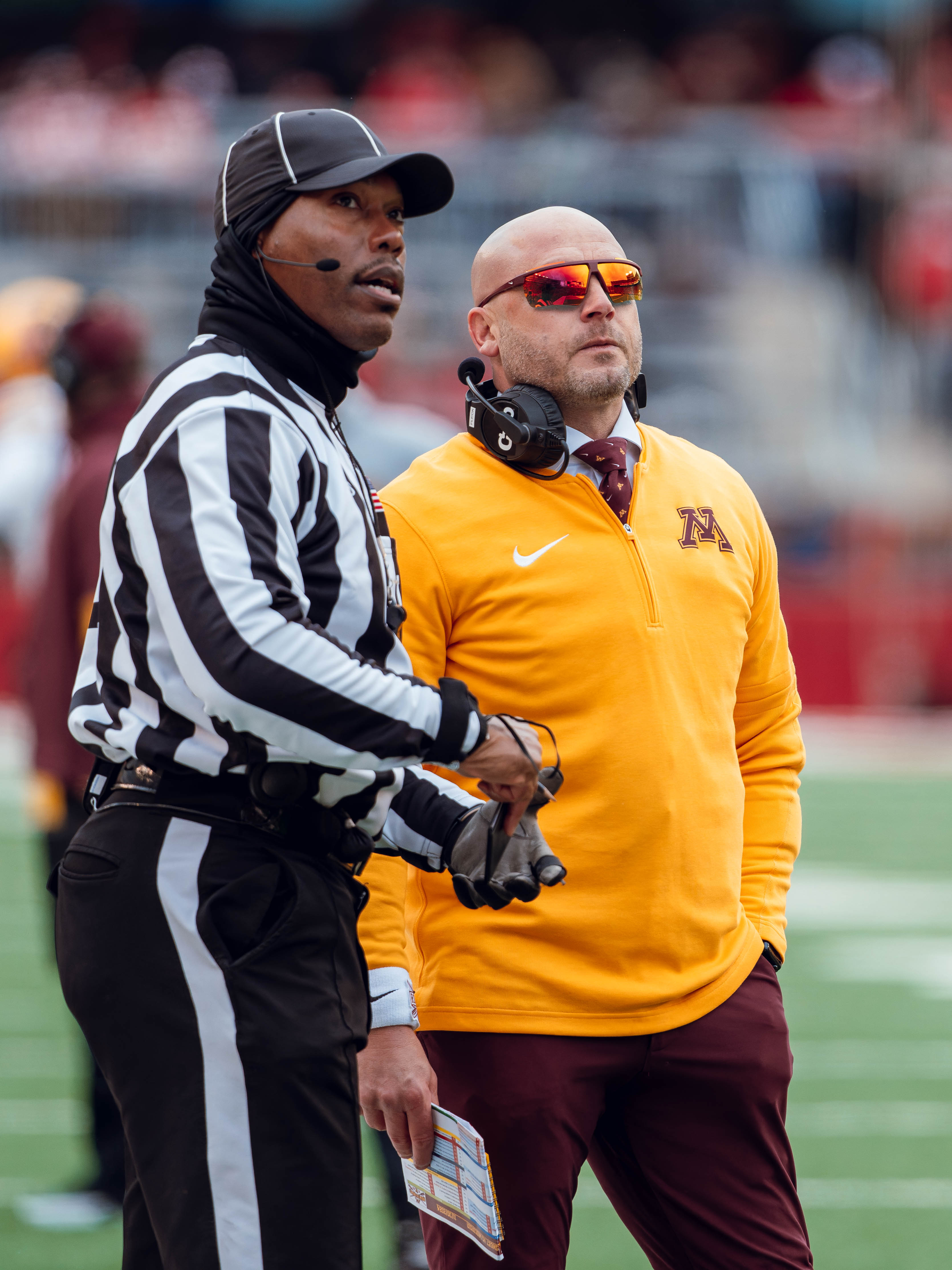 Minnesota Golden Gopher head coach P.J. Fleck looks at the scoreboard during an official review against the Wisconsin Badgers at Camp Randall Stadium on November 29, 2024 in Madison, Wisconsin. Photography by Ross Harried for Second Crop Sports.