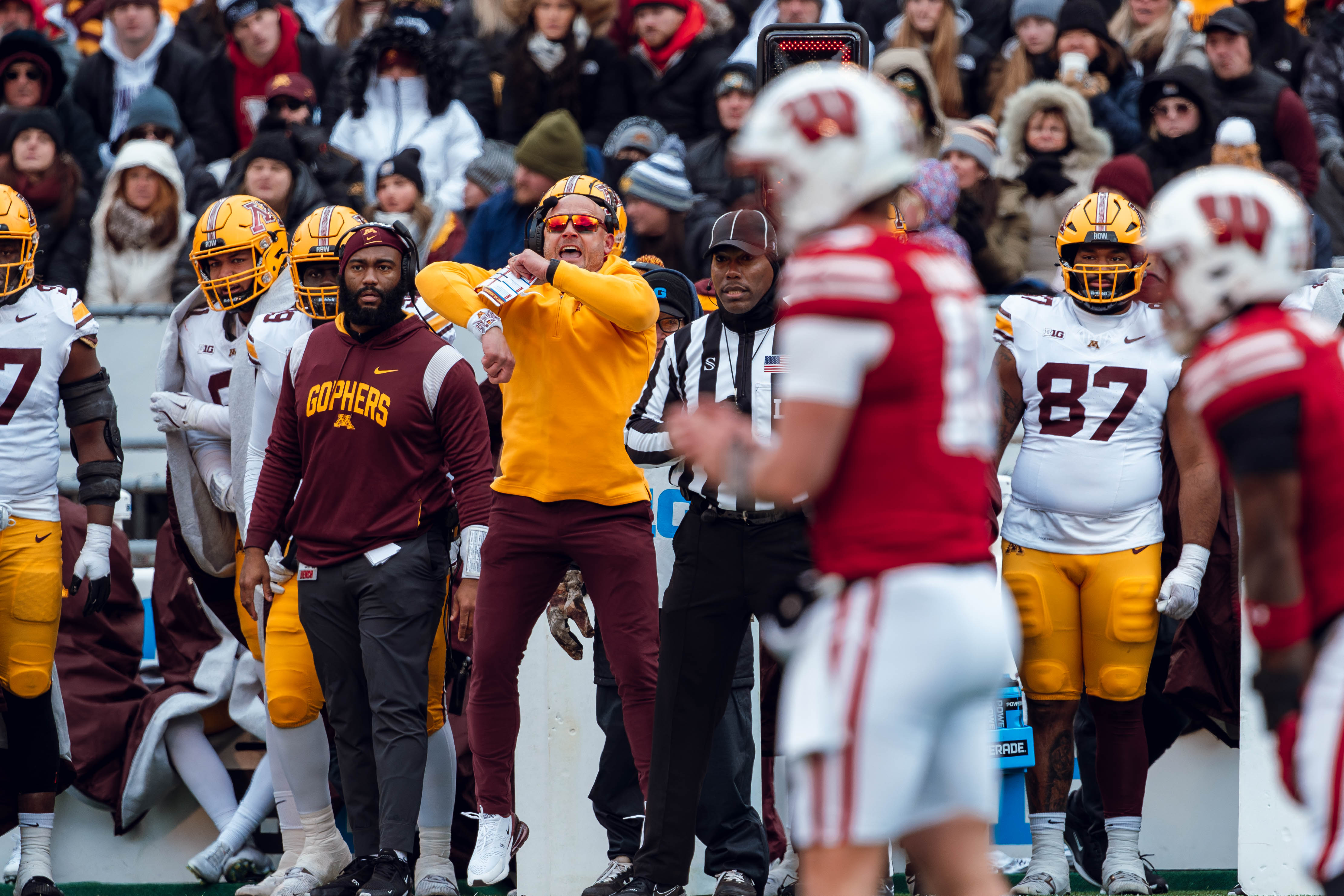 Minnesota Golden Gopher head coach P.J. Fleck jumps to signal a false start against the Wisconsin Badgers at Camp Randall Stadium on November 29, 2024 in Madison, Wisconsin. Photography by Ross Harried for Second Crop Sports.