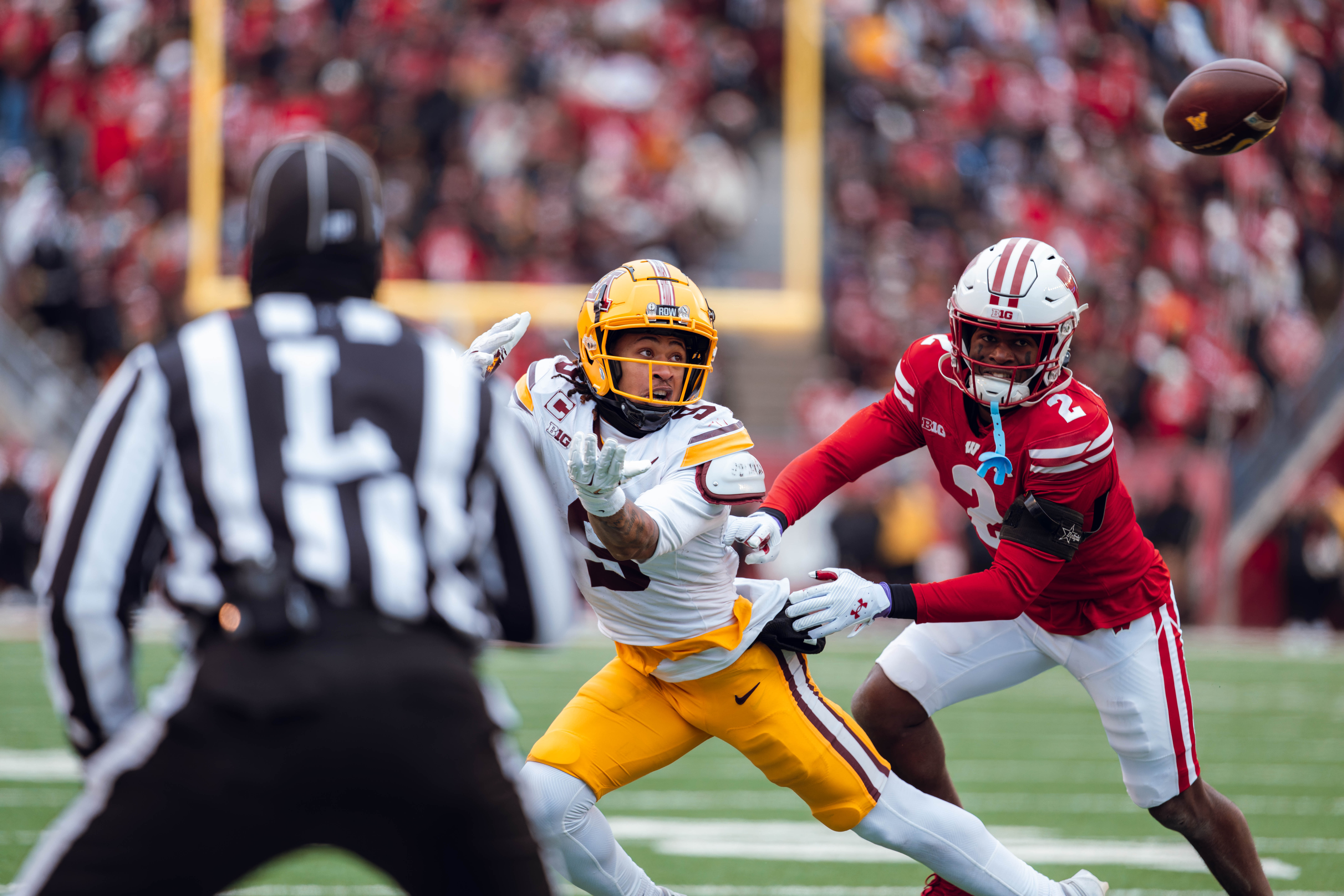 Minnesota Golden Gopher wide receiver Daniel Jackson #9 eyes a pass while defended by Wisconsin Badgers cornerback Ricardo Hallman #2 at Camp Randall Stadium on November 29, 2024 in Madison, Wisconsin. Photography by Ross Harried for Second Crop Sports.