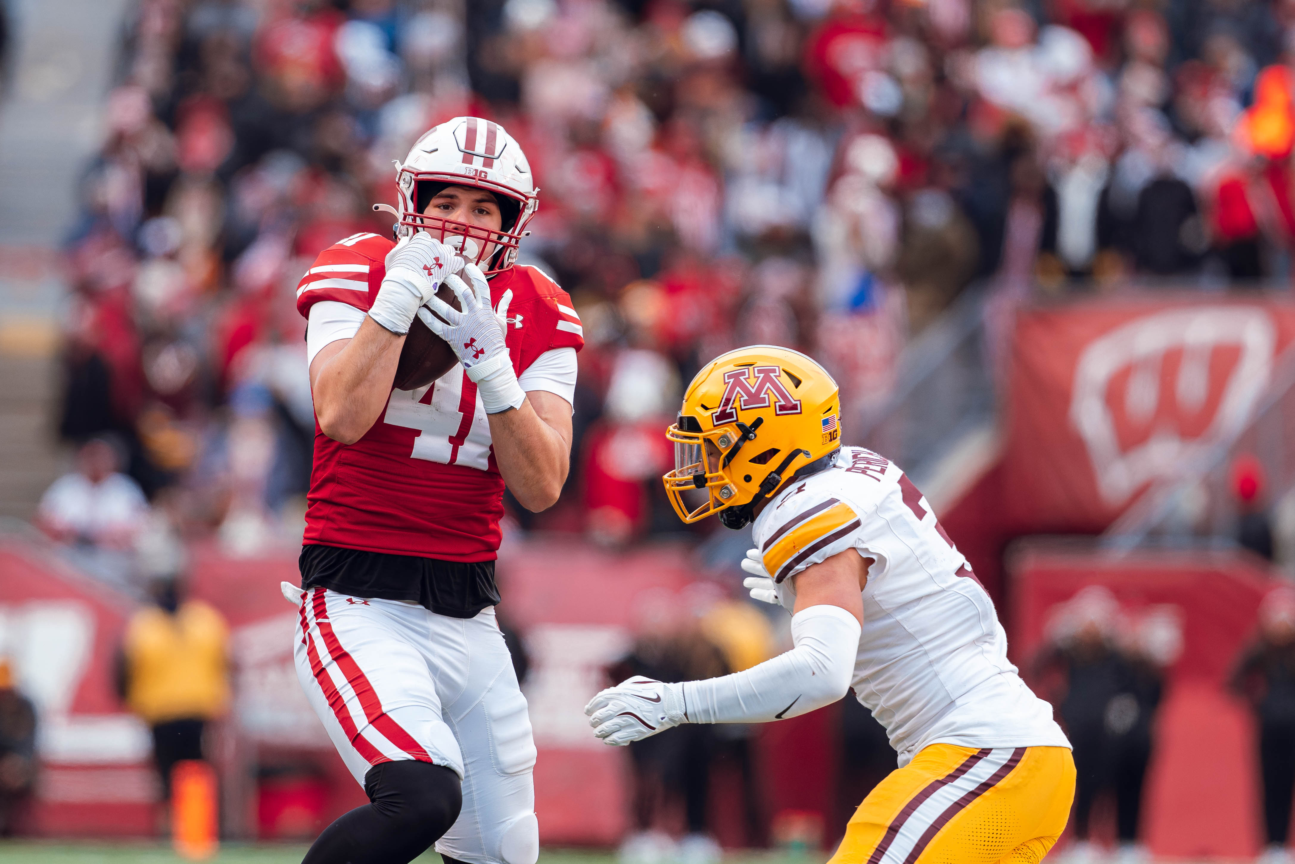 Wisconsin Badgers tight end JT Seagreaves #41 wrangles in a pass against the Minnesota Golden Gophers at Camp Randall Stadium on November 29, 2024 in Madison, Wisconsin. Photography by Ross Harried for Second Crop Sports.