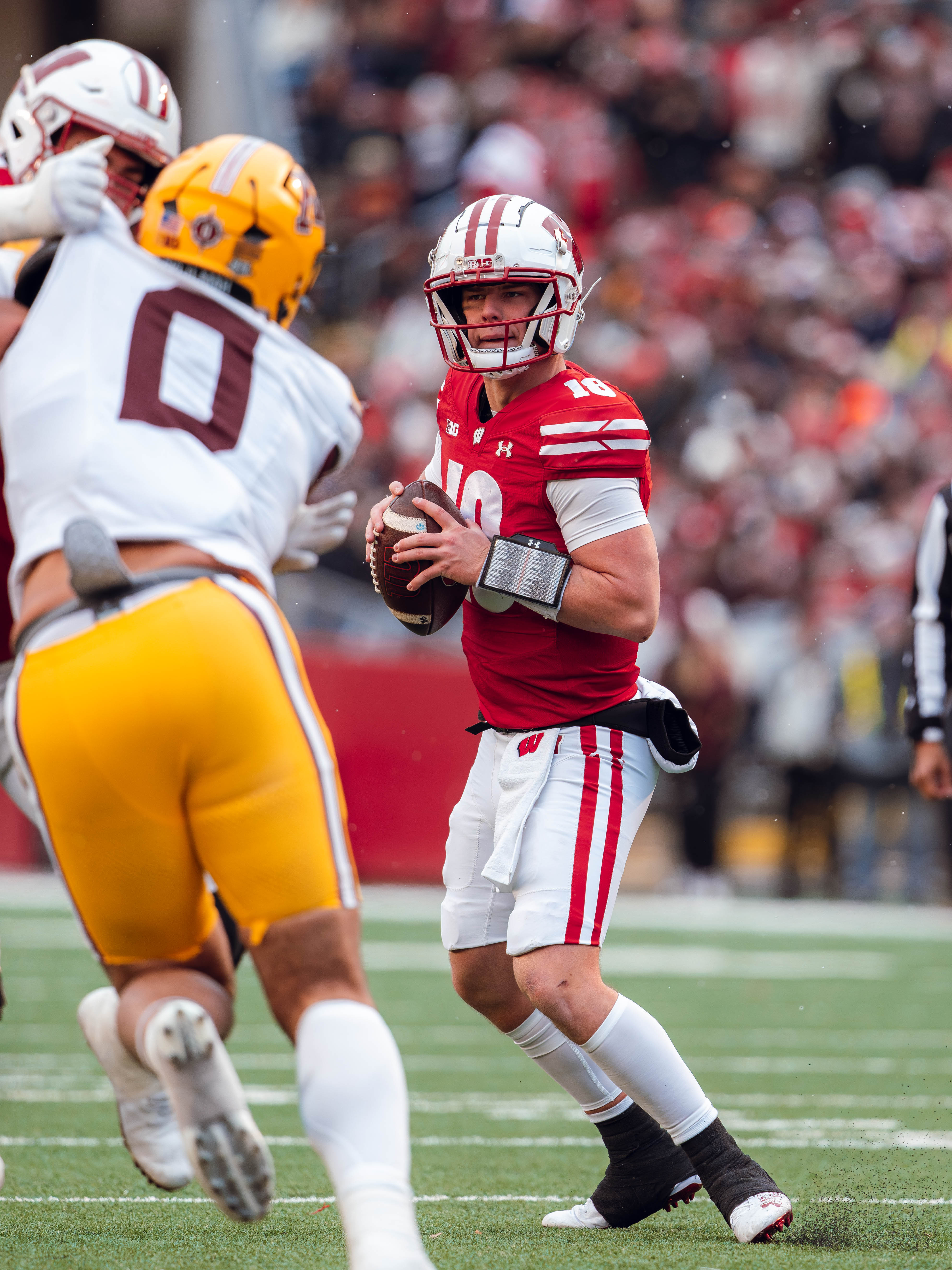 Wisconsin Badgers quarterback Braedyn Locke #18 drops back for a pass against the Minnesota Golden Gophers at Camp Randall Stadium on November 29, 2024 in Madison, Wisconsin. Photography by Ross Harried for Second Crop Sports.