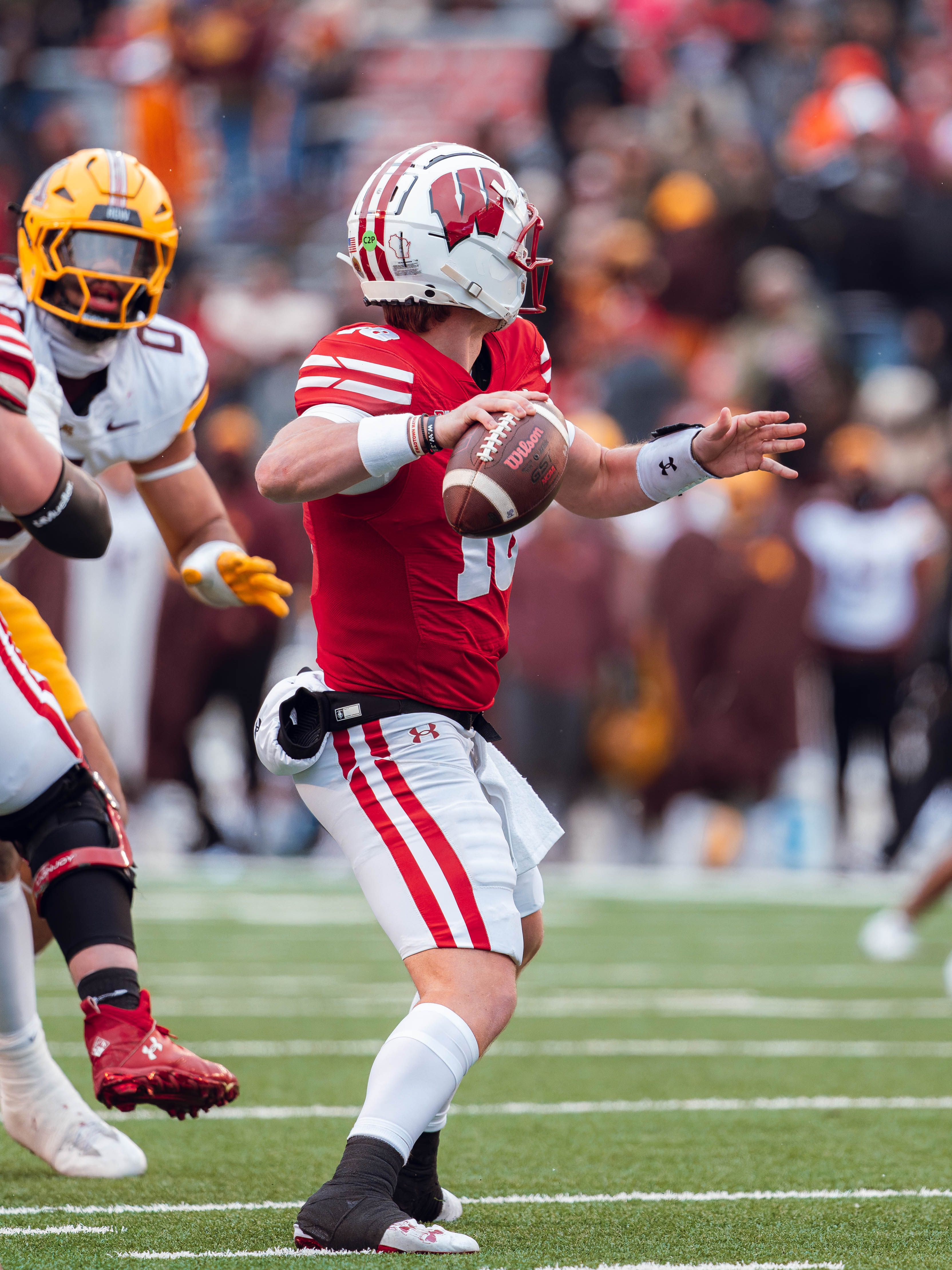 Wisconsin Badgers quarterback Braedyn Locke #18 throws a pass against the Minnesota Golden Gophers at Camp Randall Stadium on November 29, 2024 in Madison, Wisconsin. Photography by Ross Harried for Second Crop Sports.