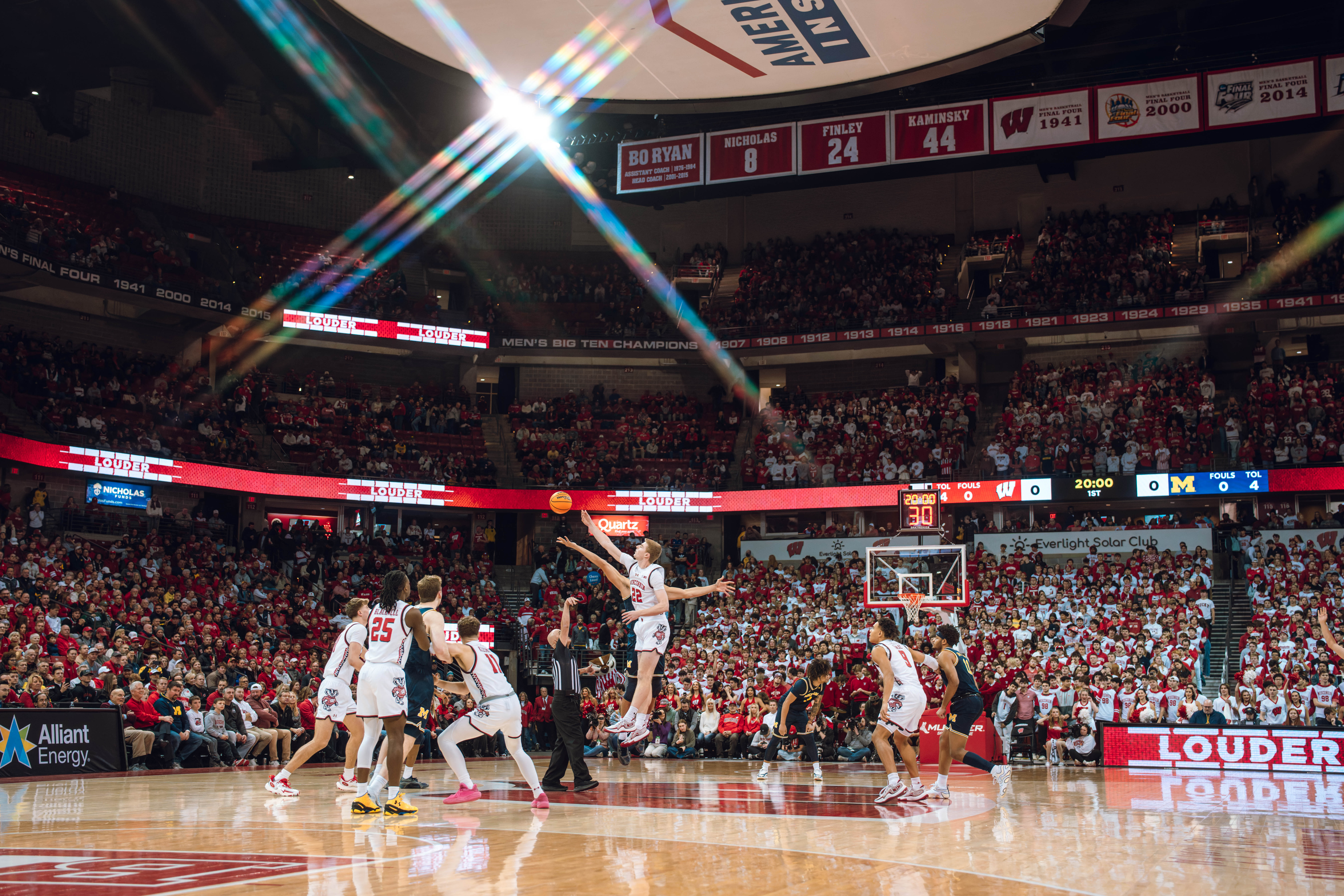 Wisconsin Badgers forward Steven Crowl #22 has the first touch of the tipoff against the Michigan Wolverines at the Kohl Center on December 03, 2024 in Madison, Wisconsin. Photography by Ross Harried for Second Crop Sports.