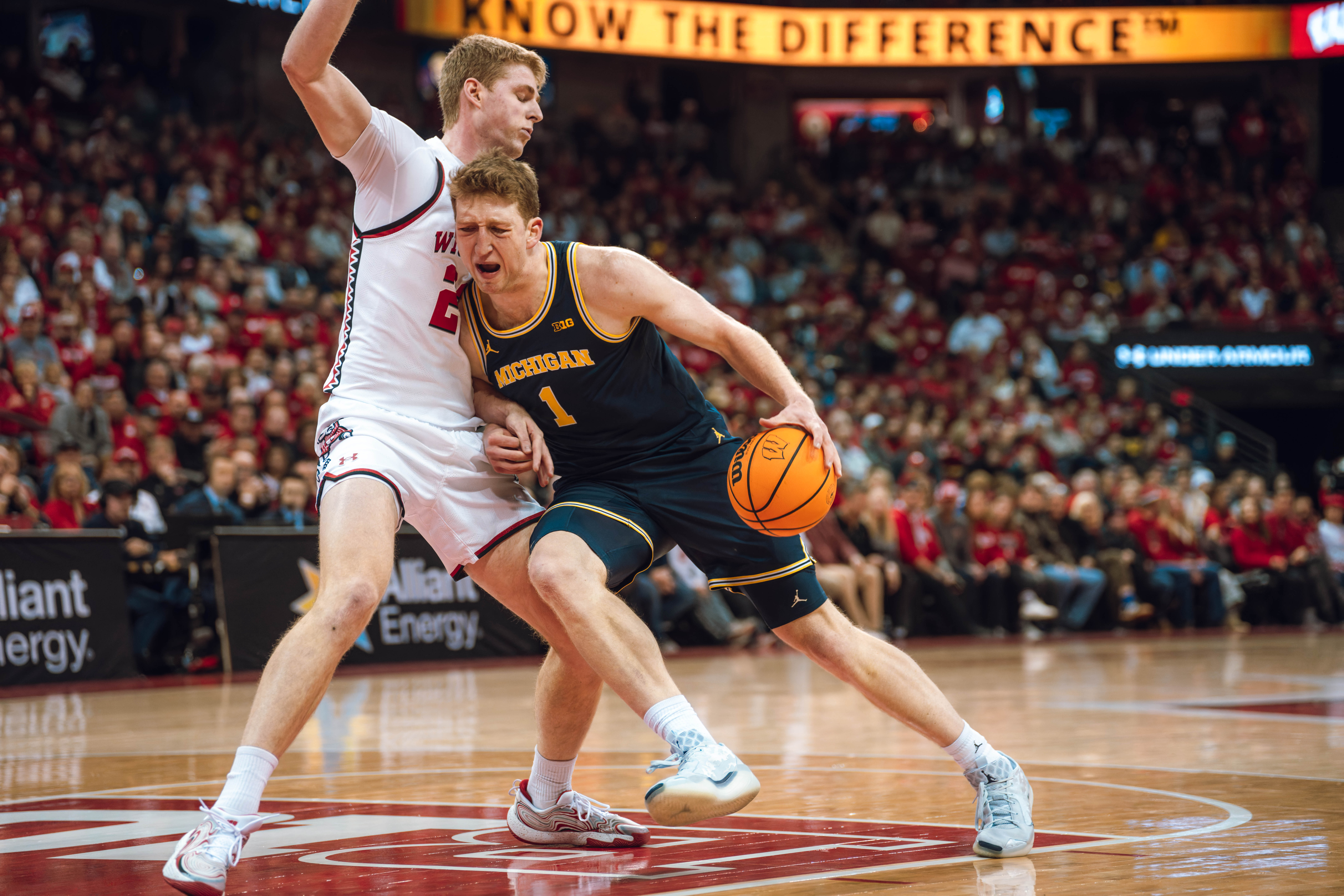 Michigan Wolverines center Danny Wolf #1 drives into the lane while being defended by Wisconsin Badgers forward Steven Crowl #22 at the Kohl Center on December 03, 2024 in Madison, Wisconsin. Photography by Ross Harried for Second Crop Sports.