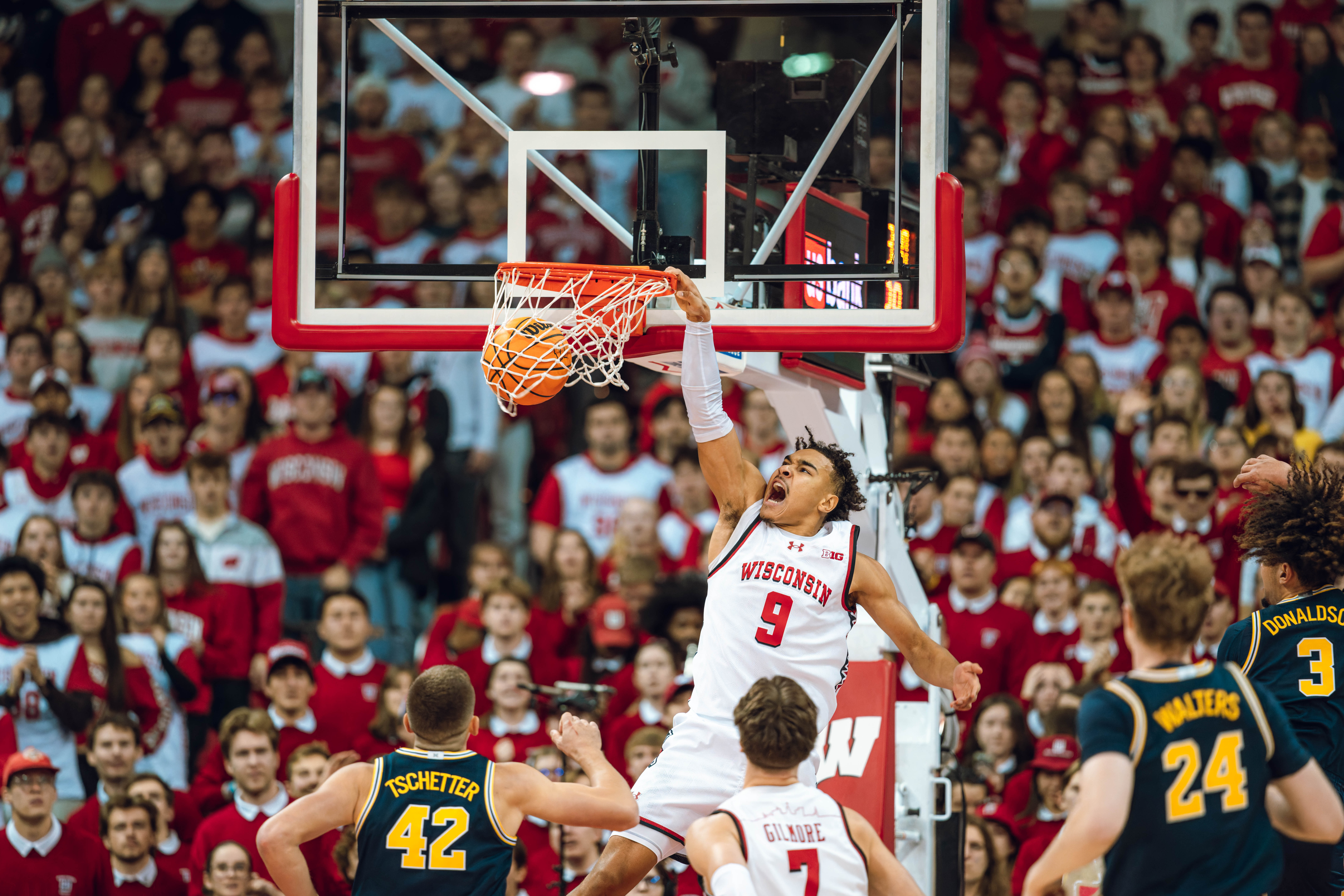 Wisconsin Badgers guard John Tonje #9 slams down a dunk on a fast break against the Michigan Wolverines at the Kohl Center on December 03, 2024 in Madison, Wisconsin. Photography by Ross Harried for Second Crop Sports.