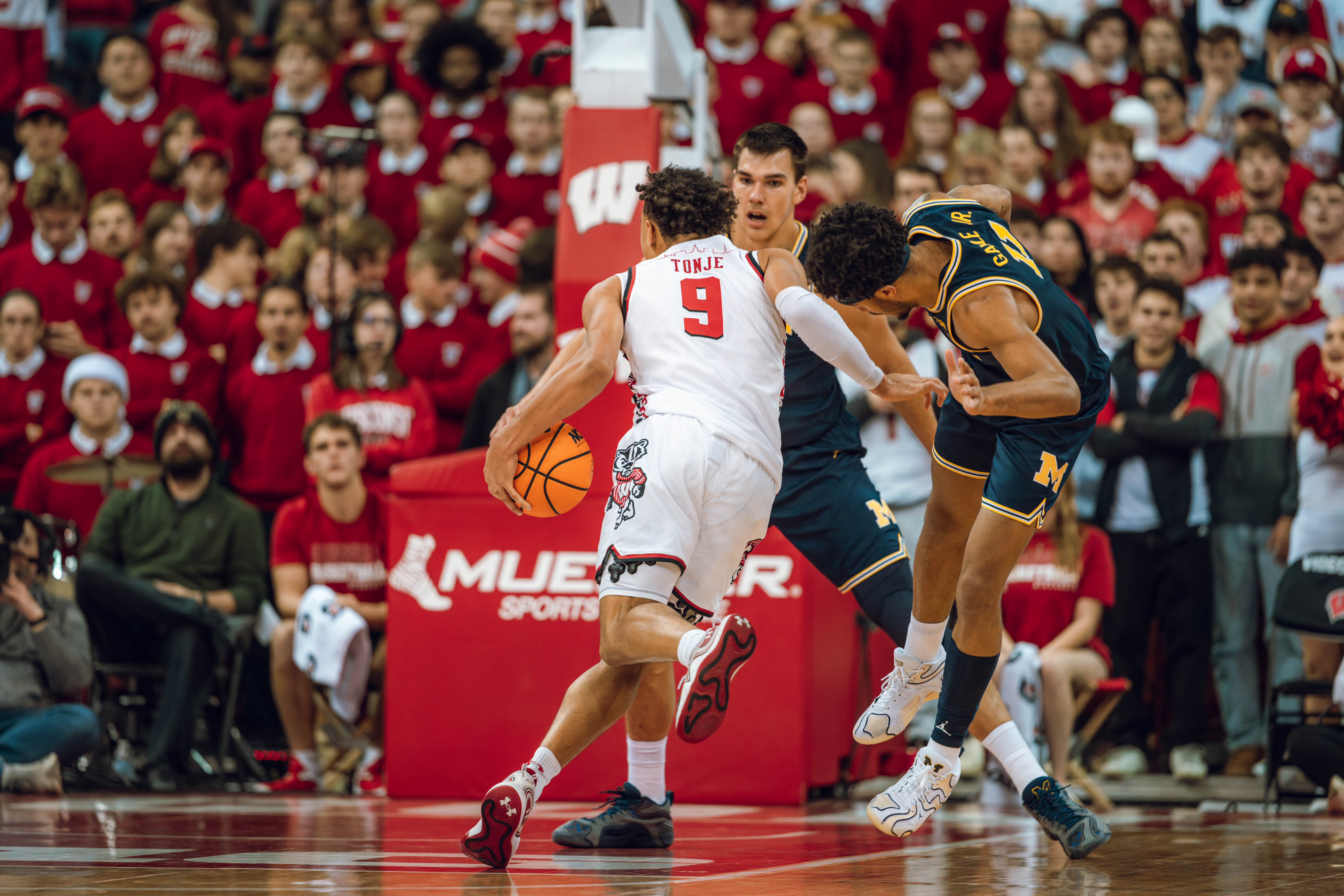 Wisconsin Badgers guard John Tonje #9 drives the lane as Michigan Wolverines guard Roddy Gayle Jr. #11 gets left behind at the Kohl Center on December 03, 2024 in Madison, Wisconsin. Photography by Ross Harried for Second Crop Sports.