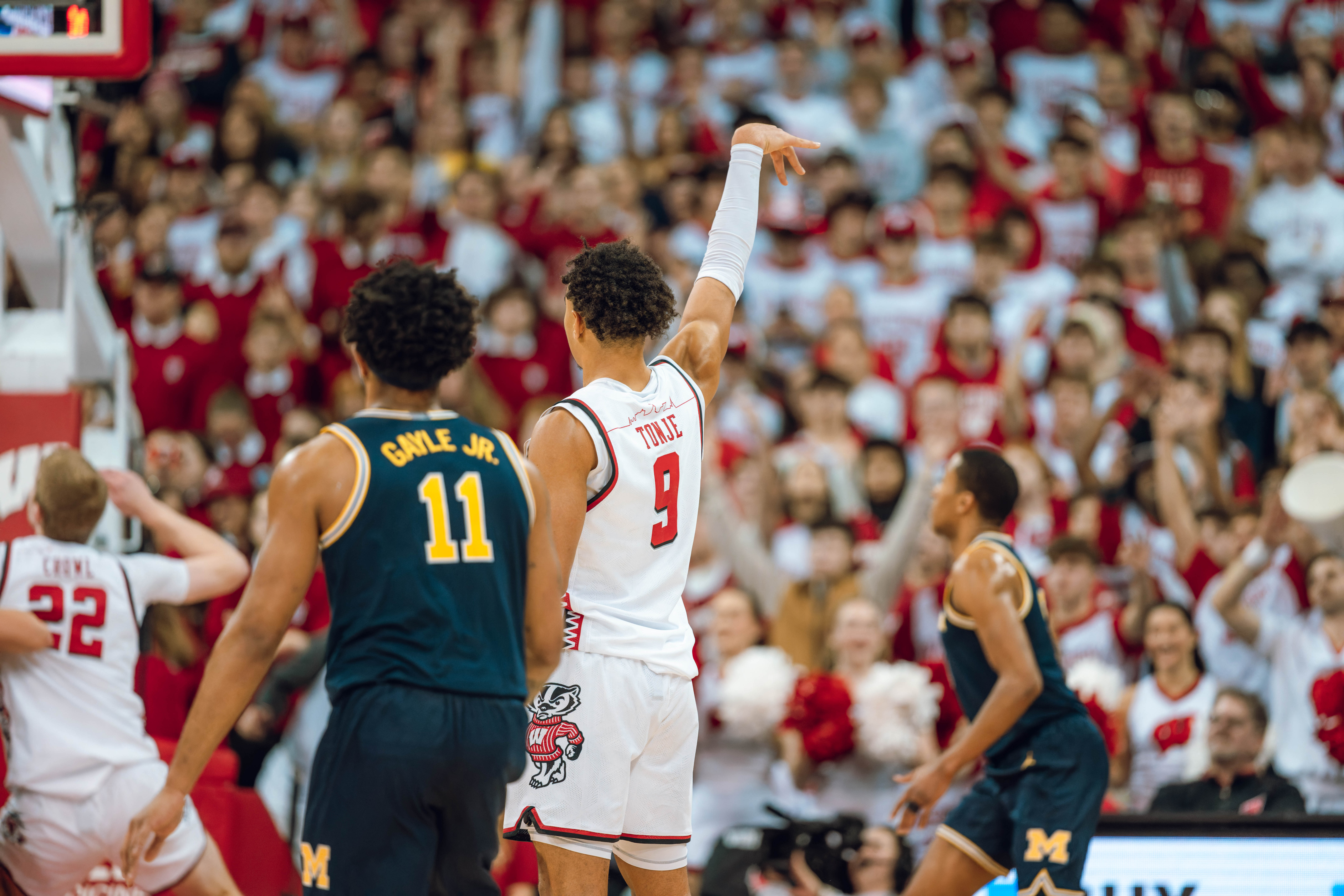 Wisconsin Badgers guard John Tonje #9 holds a follow through as Michigan Wolverines guard Roddy Gayle Jr. #11 looks on at the Kohl Center on December 03, 2024 in Madison, Wisconsin. Photography by Ross Harried for Second Crop Sports.