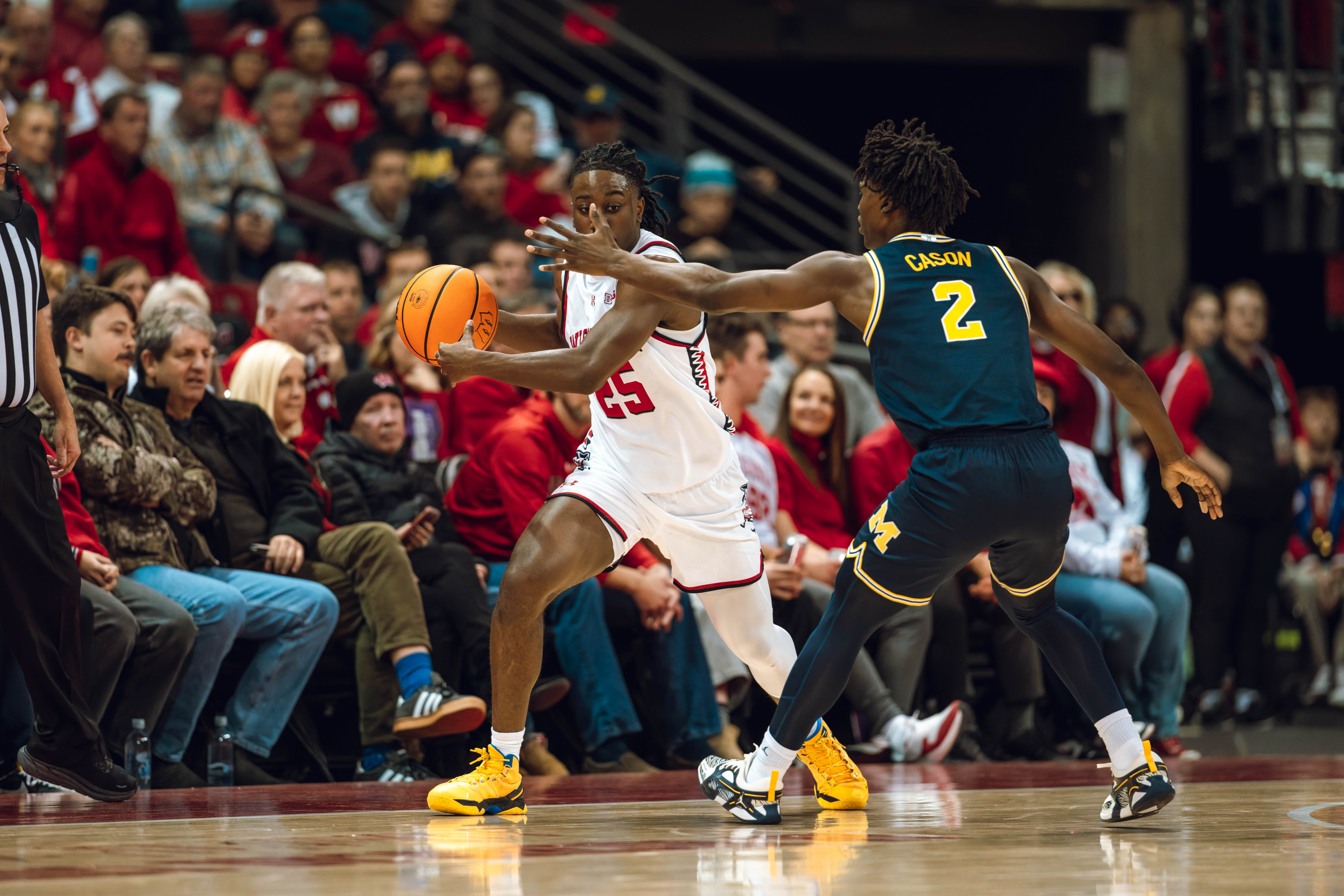 Wisconsin Badgers guard John Blackwell #25 is defended by Michigan Wolverines guard L.J. Cason #2 at the Kohl Center on December 03, 2024 in Madison, Wisconsin. Photography by Ross Harried for Second Crop Sports.