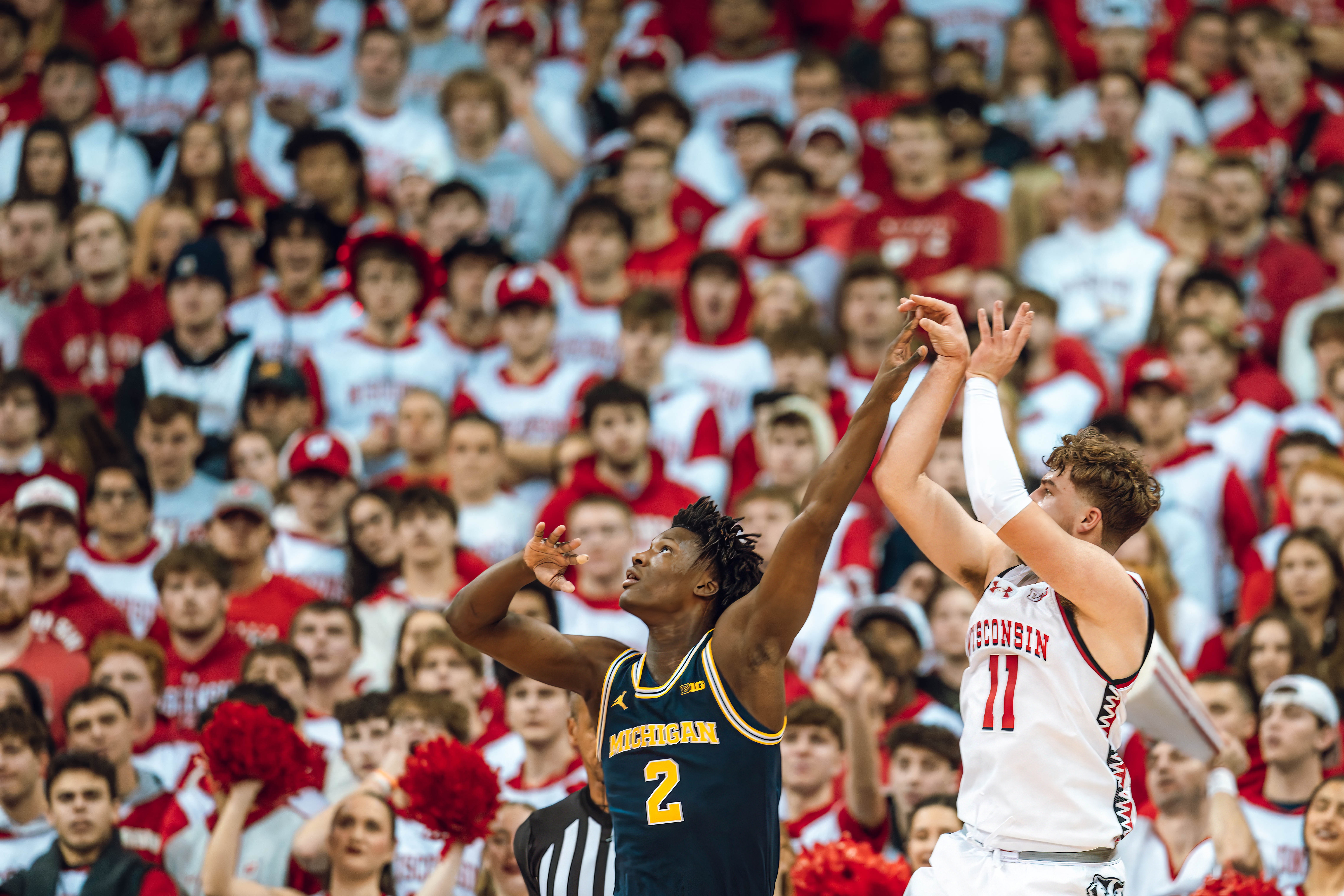 Wisconsin Badgers guard Max Klesmit #11 shoots a jumper over Michigan Wolverines guard L.J. Cason #2 at the Kohl Center on December 03, 2024 in Madison, Wisconsin. Photography by Ross Harried for Second Crop Sports.