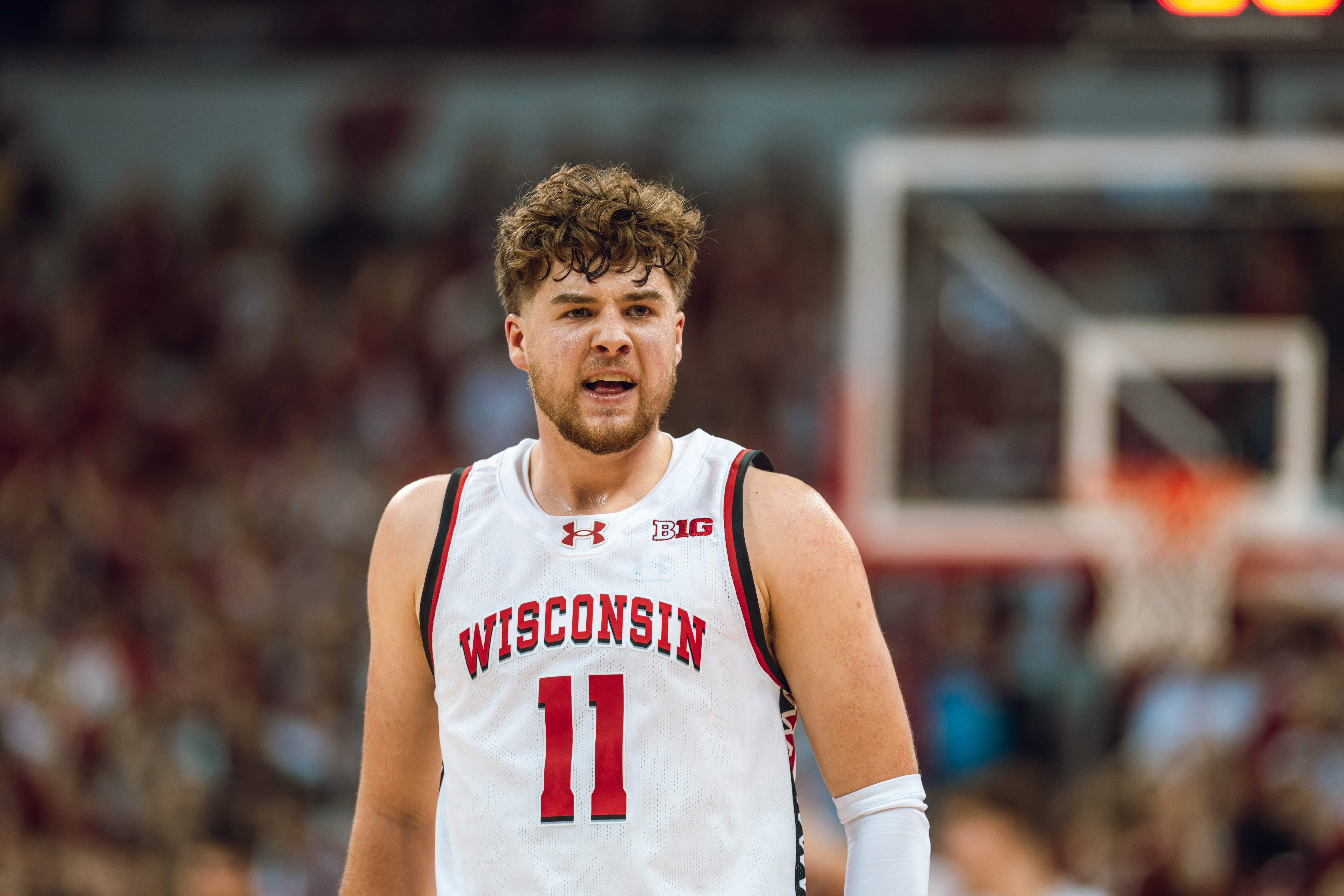 Wisconsin Badgers guard Max Klesmit #11 walks back to the bench during a media time out against the Michigan Wolverines at the Kohl Center on December 03, 2024 in Madison, Wisconsin. Photography by Ross Harried for Second Crop Sports.