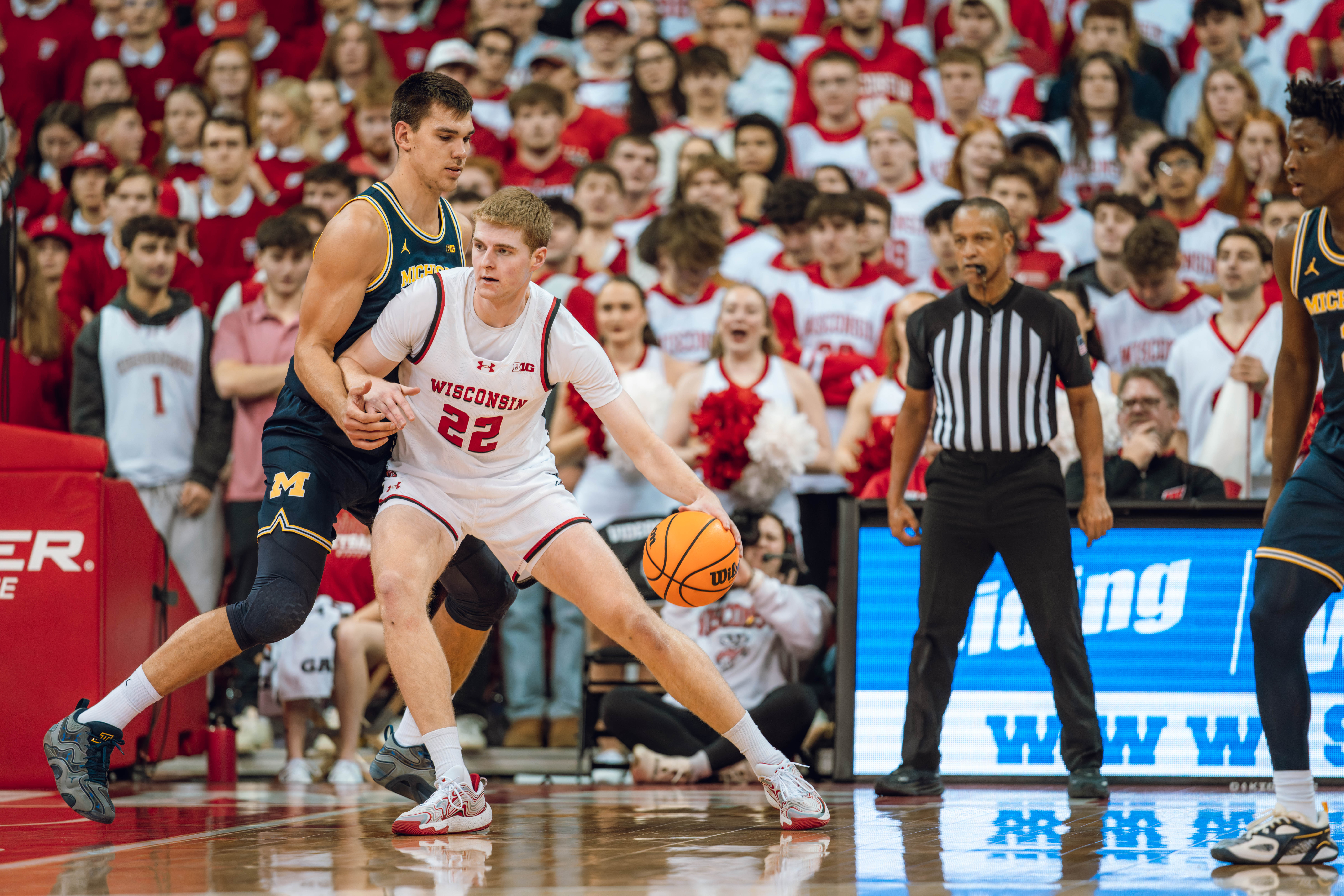 Wisconsin Badgers forward Steven Crowl #22 is defended by Michigan Wolverines center Vladislav Goldin #50 at the Kohl Center on December 03, 2024 in Madison, Wisconsin. Photography by Ross Harried for Second Crop Sports.