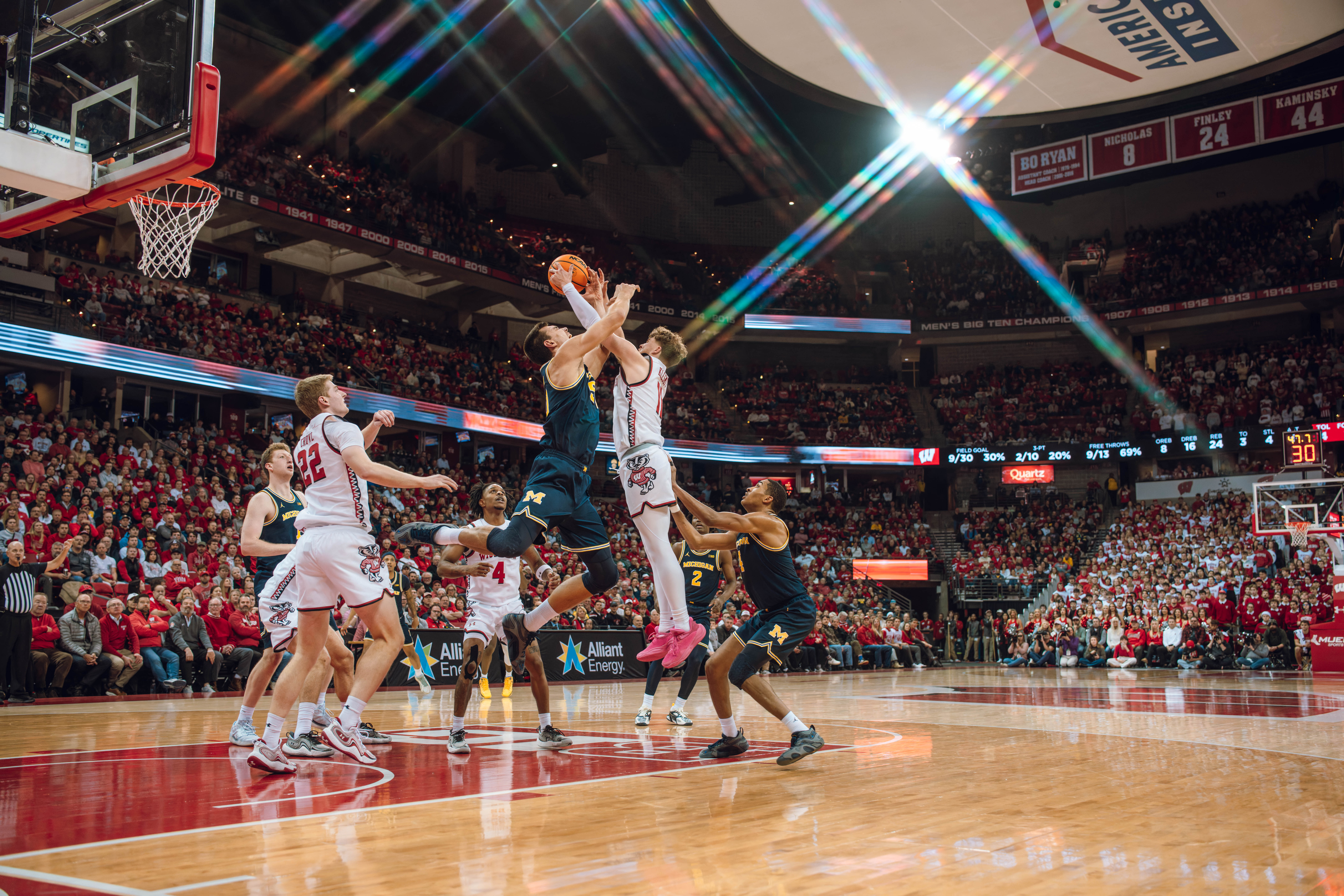 Wisconsin Badgers guard Max Klesmit #11 and Michigan Wolverines center Vladislav Goldin #50 battle over afor a rebound in the second half at the Kohl Center on December 03, 2024 in Madison, Wisconsin. Photography by Ross Harried for Second Crop Sports.