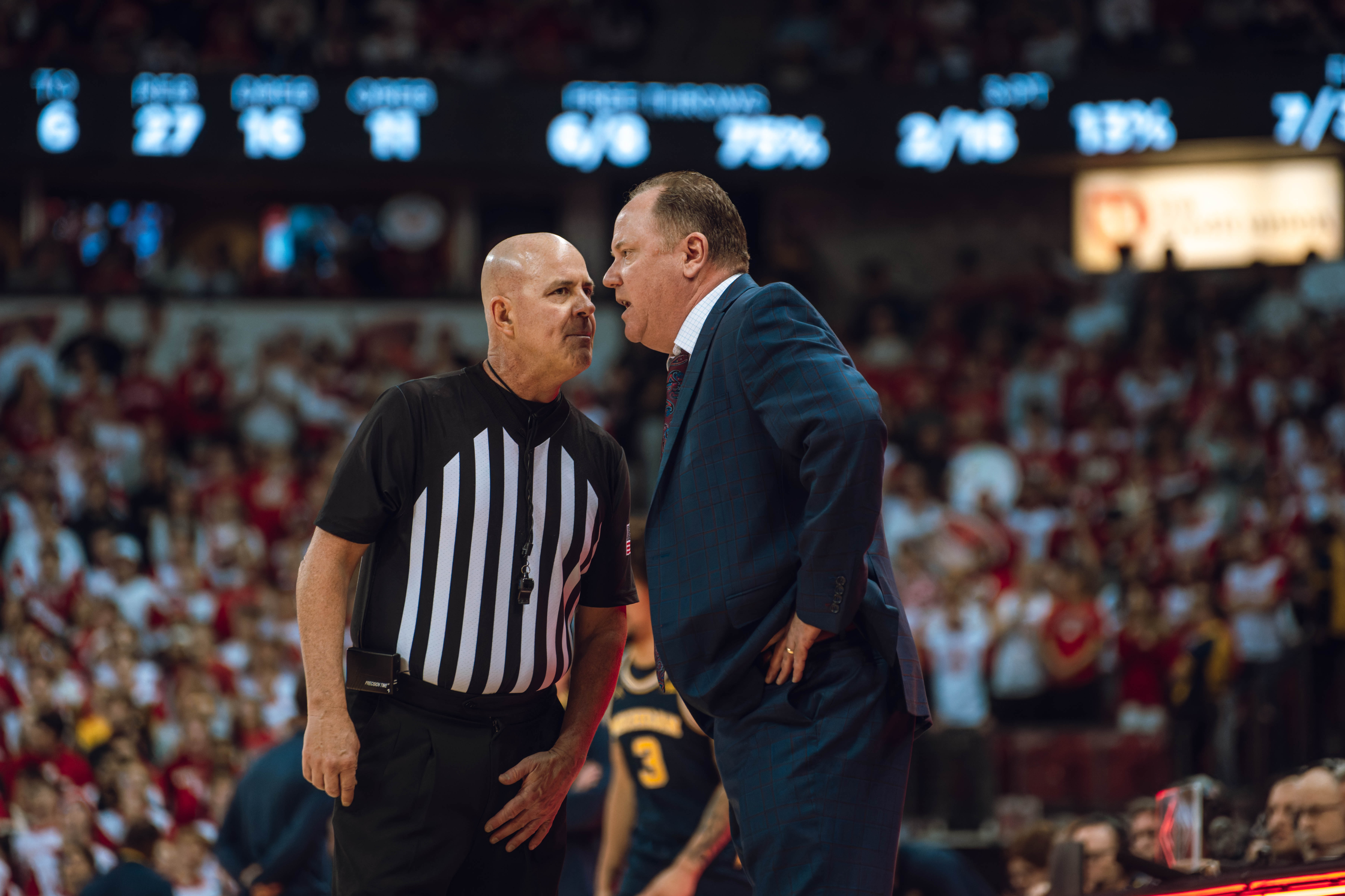 Wisconsin Badgers head coach Greg Gard gets an explanation from the referee against the Michigan Wolverines at the Kohl Center on December 03, 2024 in Madison, Wisconsin. Photography by Ross Harried for Second Crop Sports.