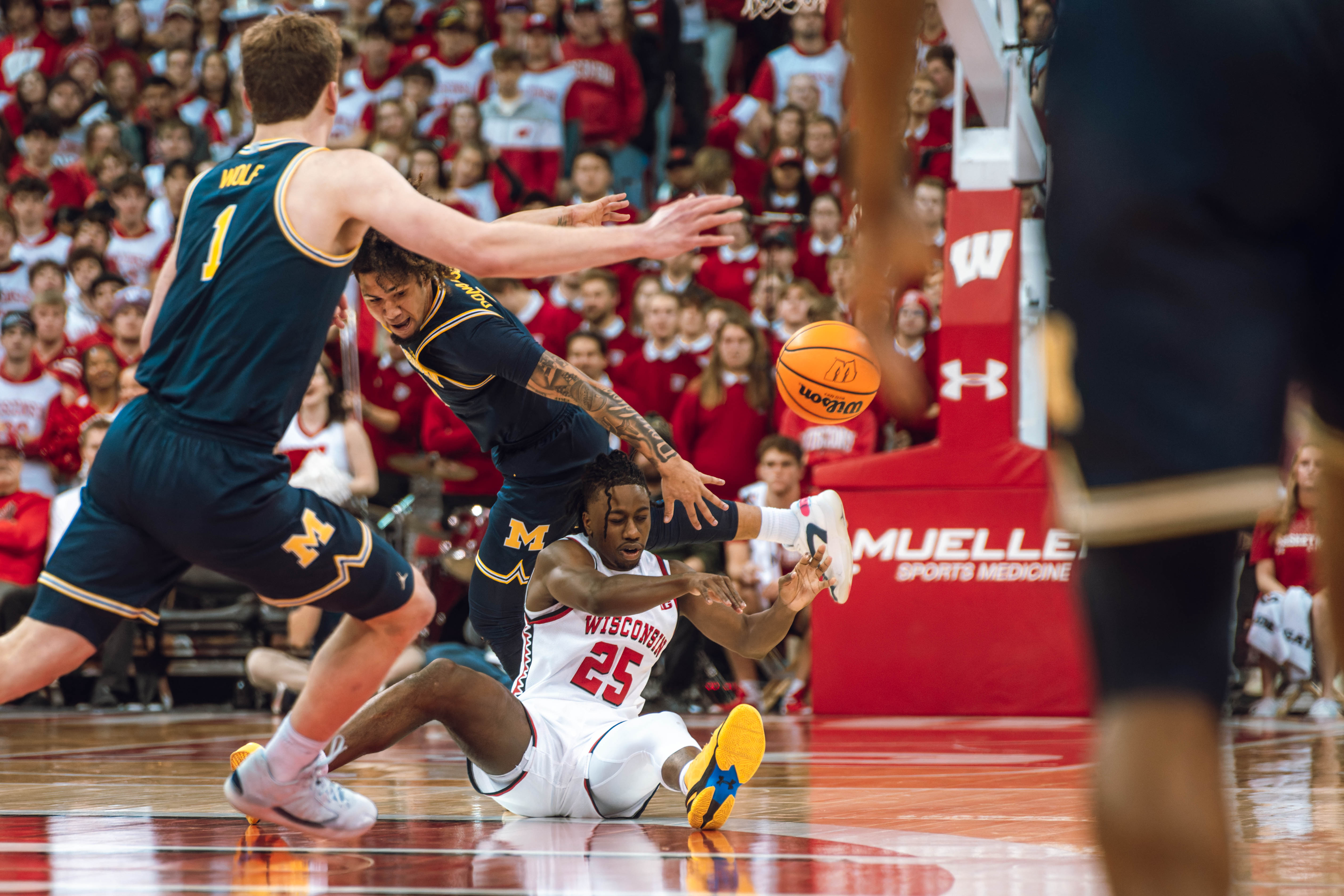 Wisconsin Badgers guard John Blackwell #25 scoops up a loose ball against the Michigan Wolverines at the Kohl Center on December 03, 2024 in Madison, Wisconsin. Photography by Ross Harried for Second Crop Sports.