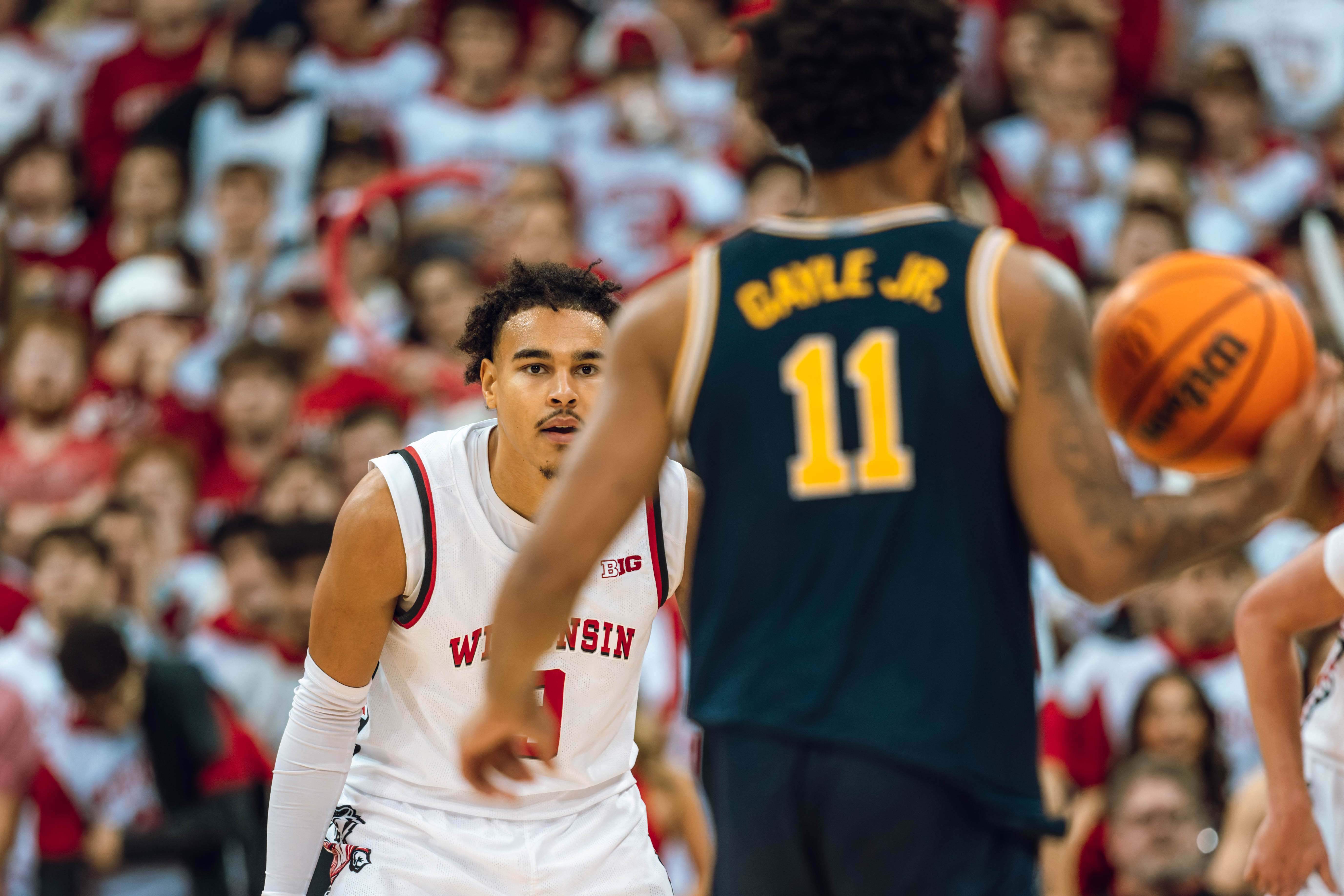 Wisconsin Badgers guard John Tonje #9 eyes Michigan Wolverines guard Roddy Gayle Jr. #11 at the Kohl Center on December 03, 2024 in Madison, Wisconsin. Photography by Ross Harried for Second Crop Sports.