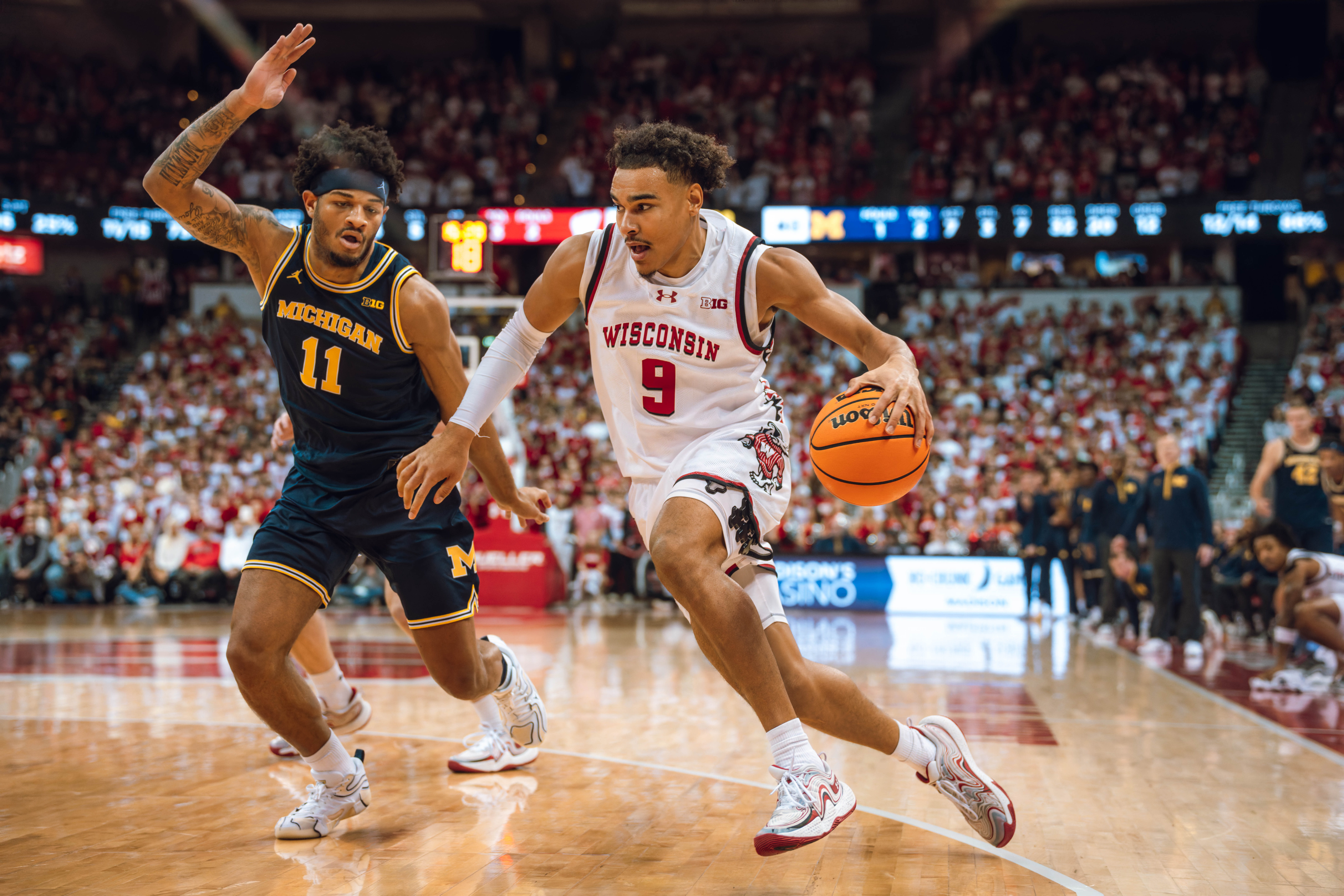 Wisconsin Badgers guard John Tonje #9 drives the baseline against Michigan Wolverines guard Roddy Gayle Jr. #11 at the Kohl Center on December 03, 2024 in Madison, Wisconsin. Photography by Ross Harried for Second Crop Sports.