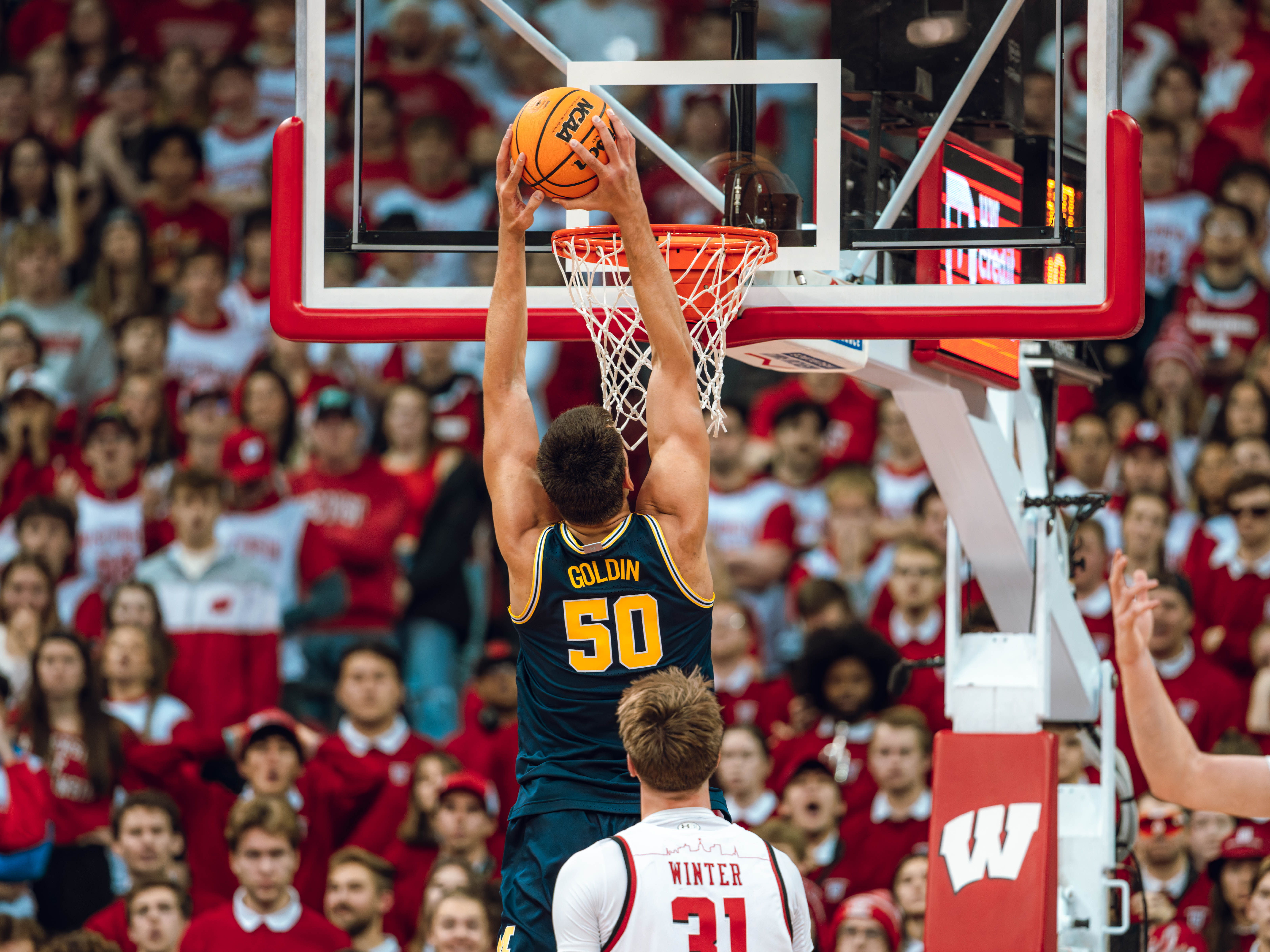 Michigan Wolverines center Vladislav Goldin #50 elevates for a dunk against the Wisconsin Badgers at the Kohl Center on December 03, 2024 in Madison, Wisconsin. Photography by Ross Harried for Second Crop Sports.